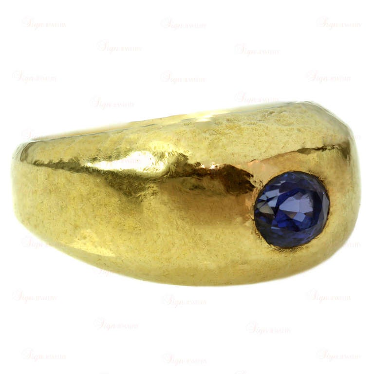 A classic 1960s ring designed by Schlumberger for Tiffany & Co. This authentic dome-shaped ring is made in 18k yellow hammered gold and bezel-set with an all natural bright and sparkling 0.75 carat fancy sapphire in beautiful royal blue tones. Ring