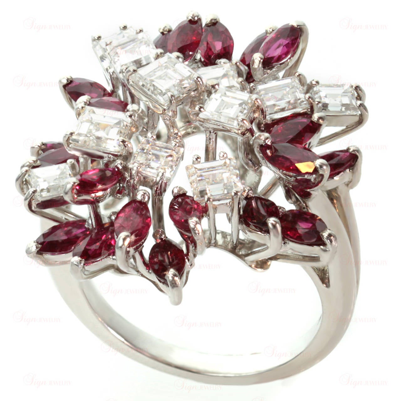 This elegant estate ring features a floral cluster of 20 marquise-cut faceted 2.0mm rubies and 11 square-cut diamonds beautifully prong-set into 18k white gold. Measurements: 0.98