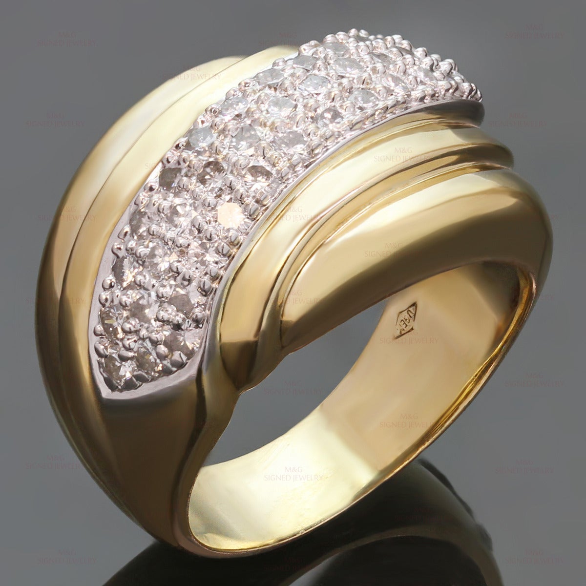 This classic womens ring is crafted in 18k yellow and white gold and set with brilliant-cut round G-H VS1-VS2 diamonds of an estimated 0.58 carats. Made in United States circa 1990s. Measurements: 0.55" (14mm) width. The ring size is 6.75 - EU