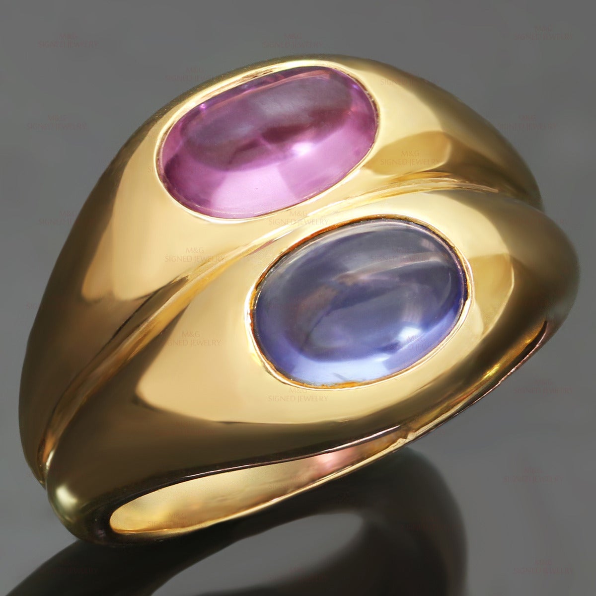 This fabulous Bvlgari Ring is crafted in 18k yellow gold and set with pink and blue cabochon oval sapphires of an estimated 4.0 carats. Made in Italy circa 1980s. Measurements: 0.59" (15mm) width. The ring size is 6.5 - EU 53. Resizable. Sizing
