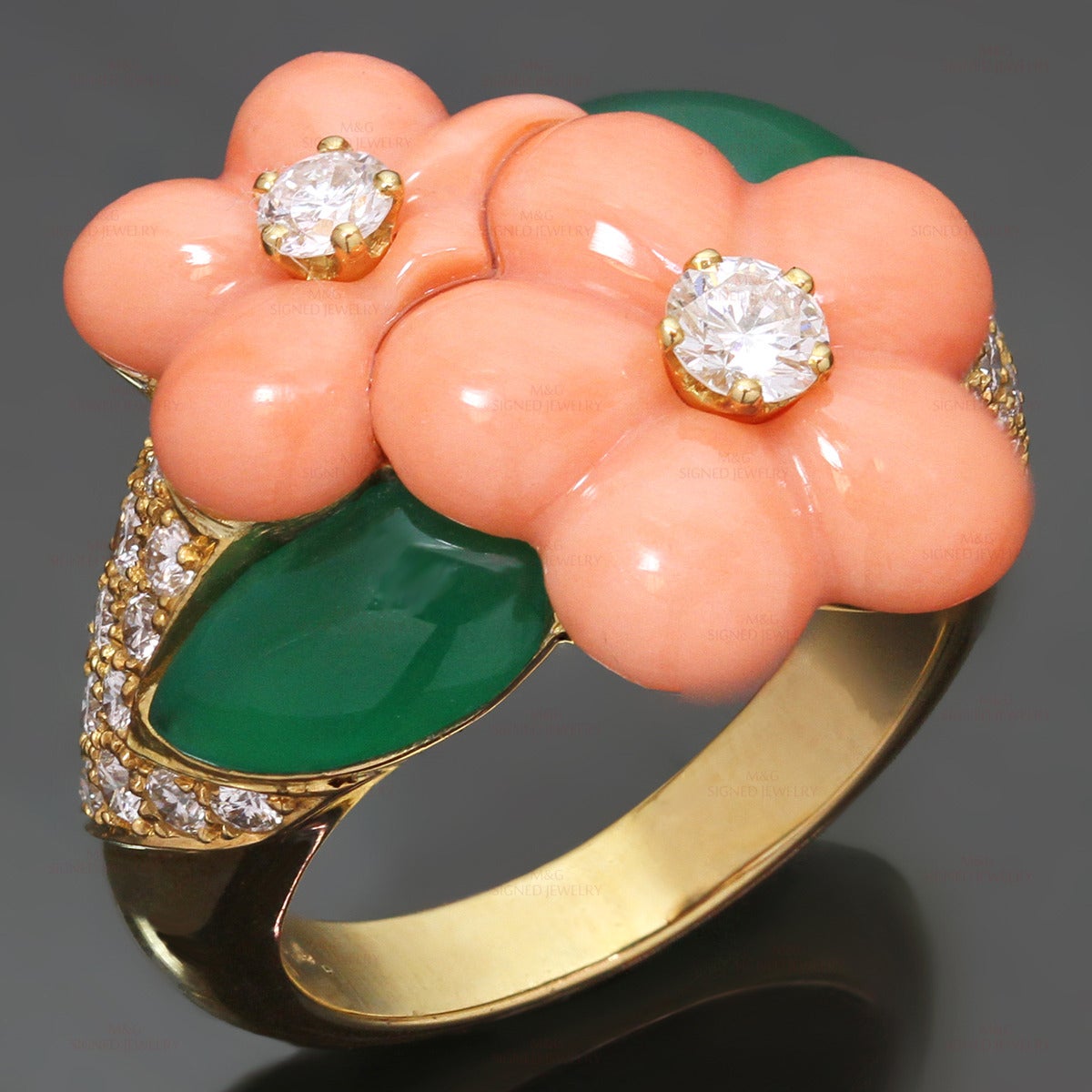 This elegant Van Cleef & Arpels ring is crafted in 18k yellow gold and beautifully inlaid with pink coral flowers and green chrysoprase leaves accented with round brilliant-cut D-F VVS1-VVS2 diamonds of an estimated 0.96 carats. Made in France