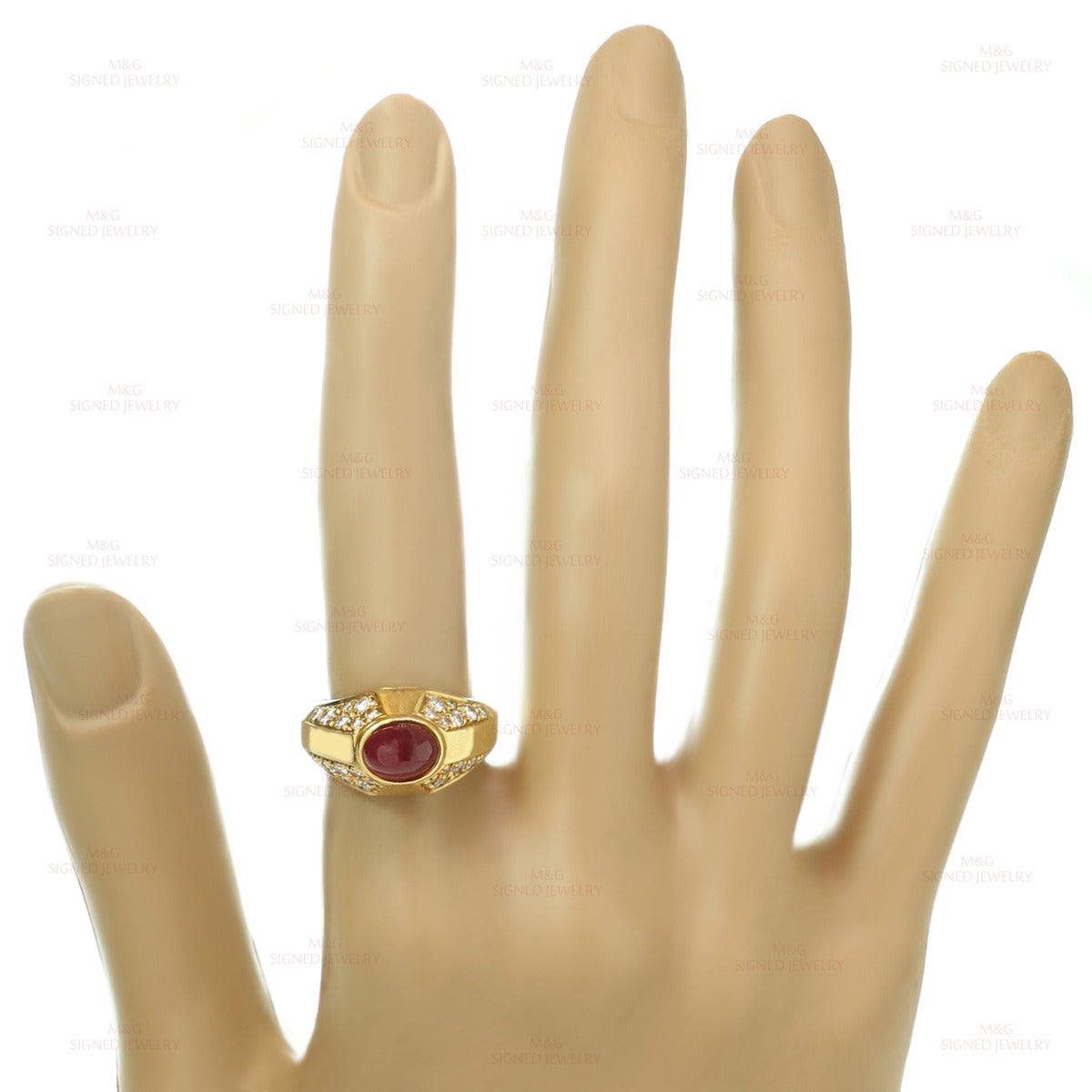 This classic Bvlgari ring is crafted in 18k yellow gold and set with a vivid red oval cabochon ruby of an estimated 2.21 carats accented with round brilliant-cut E-F VVS1-VVS2 diamonds of an estimated 0.80 carats. Made in Italy circa 1980s.