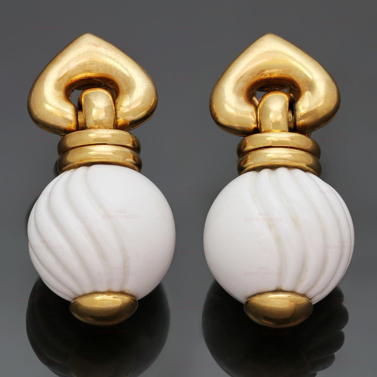 These elegant Bvlgari earrings from the Chandra collection are crafted in 18k yellow gold and feature beautifully textured white ceramic drops. Made in Italy circa 1990s. Measurements: 0.62" (16mm) width, 1.37" (35mm) length.