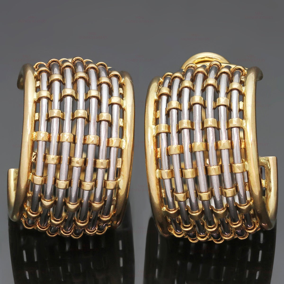 These classic Cartier hoop earrings feature a braided design crafted in 18k yellow gold and stainless steel. Made in France circa 1980s. Measurements: 0.51" (13mm) width, 0.86" (22mm) length.