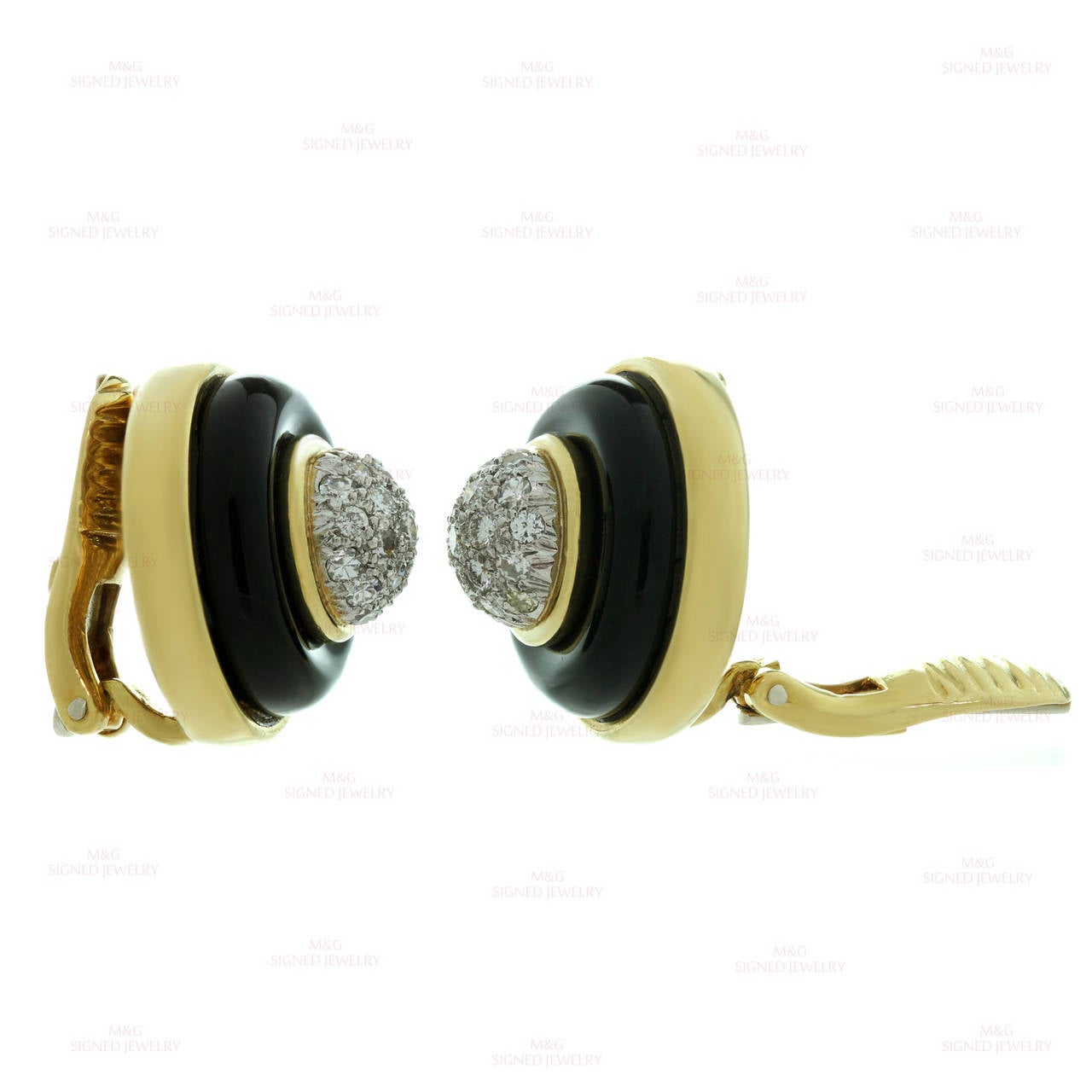 These fabulous vintage Tiffany & Co. clip-on earrings are crafted in 18k yellow gold with white gold accents and feature a dome-shaped round design inlaid with black onyx and accented with brilliant-cut round diamonds of an estimated 1.15 carats.