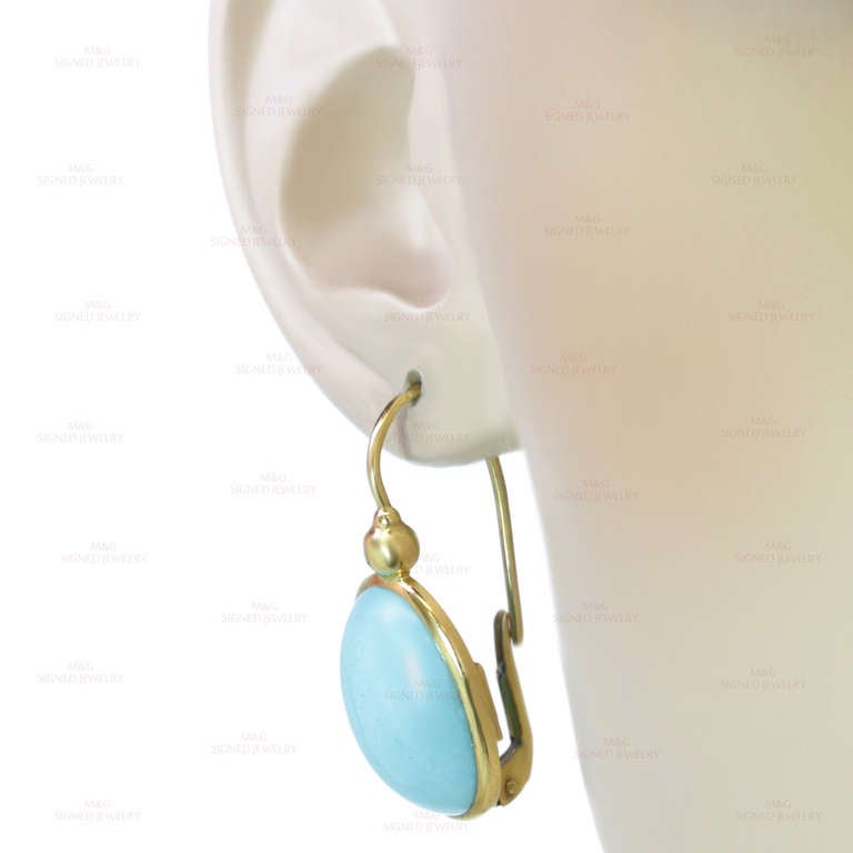 These modern earrings feature 13.0mm x 18.0mm oval turquoise drops set in 18k yellow gold. Elegant and chic. Measurements: 0.59