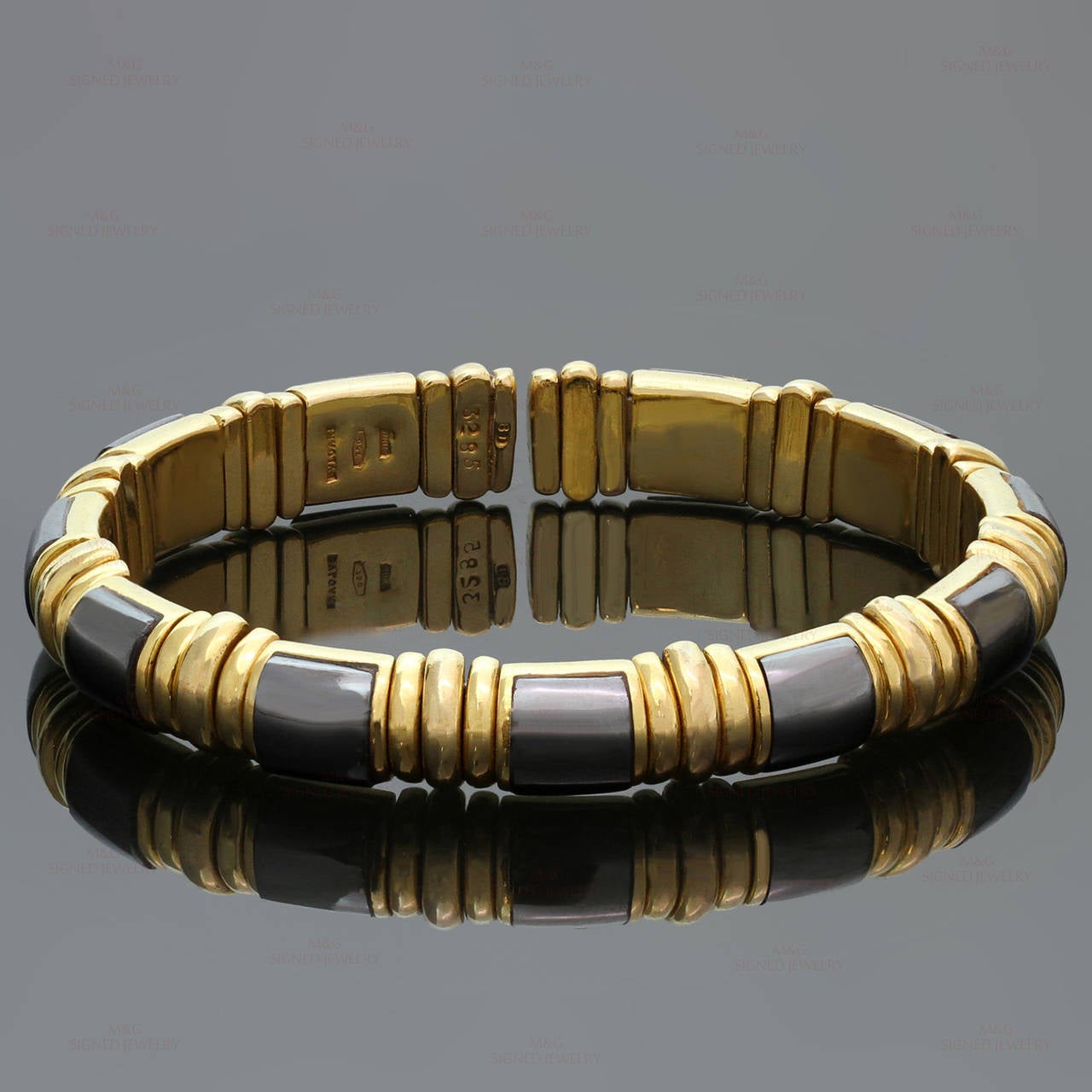 This elegant Bvlgari bangle is crafted in 18k yellow gold and inlaid with hematite. Bracelet has adjustable length from 6 to 7.25 inches. Made in Italy circa 1980s. Measurements: 0.31