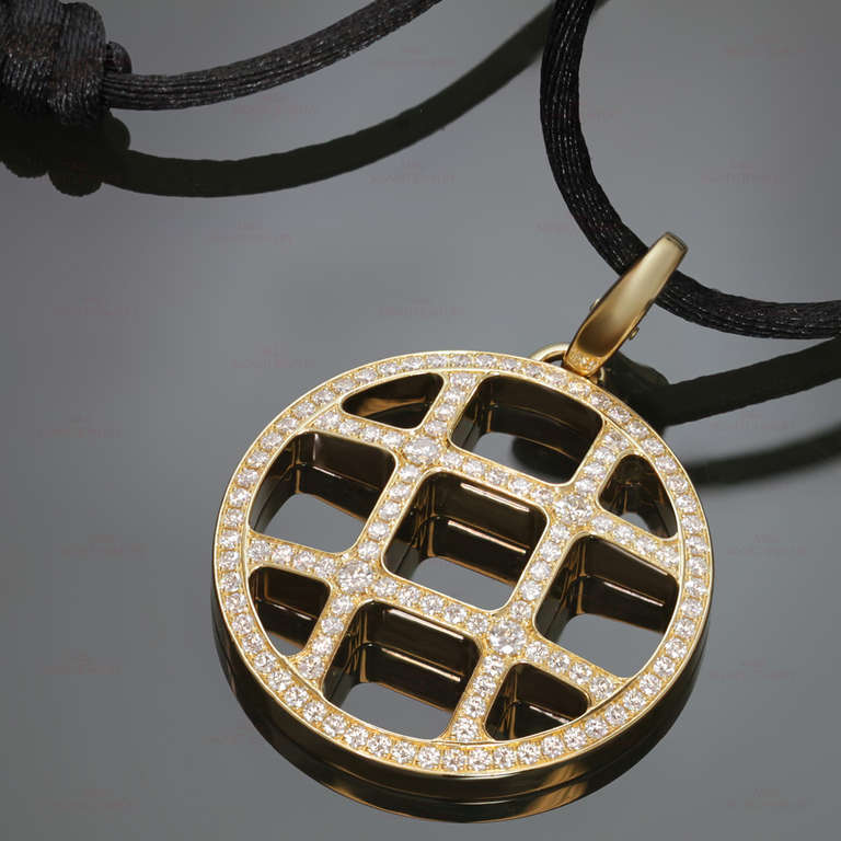 This fabulous Pasha De Cartier openwork circle pendant enhancer is made in 18k yellow gold and pave-set with brilliant-cut round E-F diamonds of an estimated 1.50 carats. Completed with an adjustable black silk cord. An iconic design. Measurements: