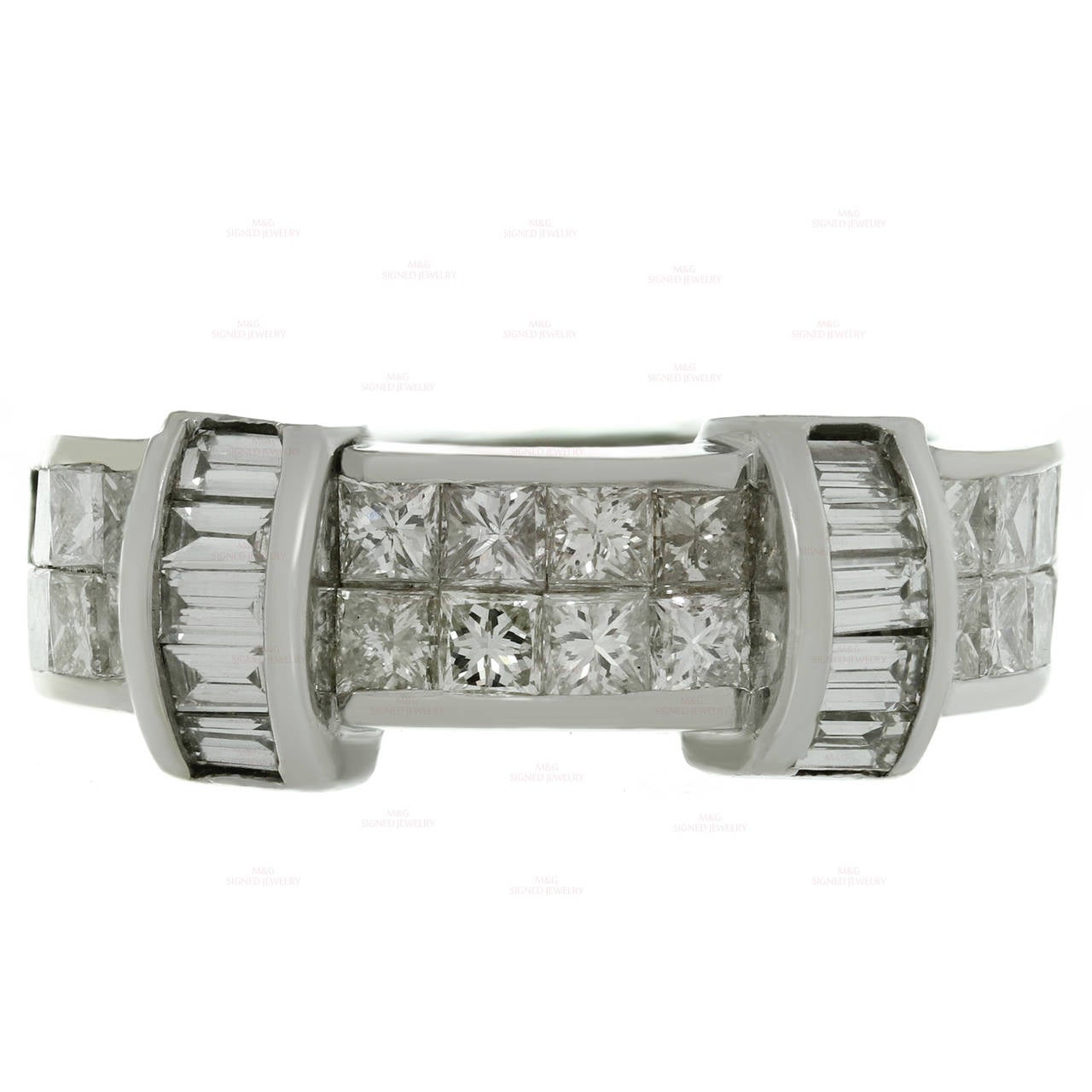 This classic estate ring is crafted in 18k white gold and beautifully set with 10 baguette-cut diamonds of an estimated 0.35 carats and 24 princess-cut diamonds of an estimated 1.65 carats.  Measurements: 0.31