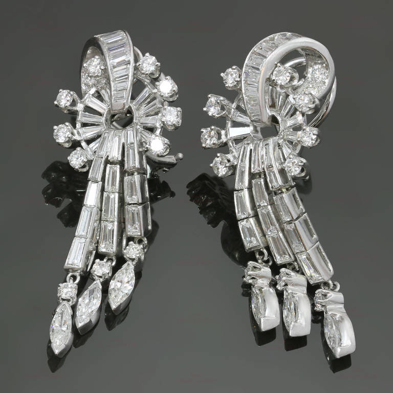 These classic dangling clip-on earring are made in fine platinum and set with an estimated 7.50 carats of multi-shaped diamonds. Posts can be added for pierced ears. A fabulously elegant 1950s design. Measurements: 0.66