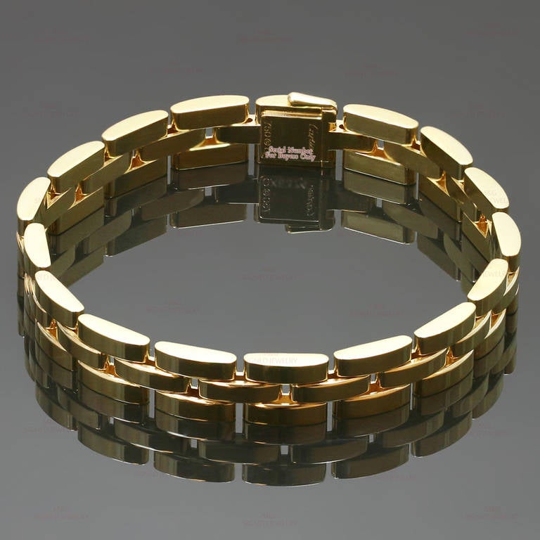 This iconic bracelet from Cartier's Panthere collection features 3 rows of solid 18k yellow gold rectangular links. Classic everyday elegance. Measurements: 0.35