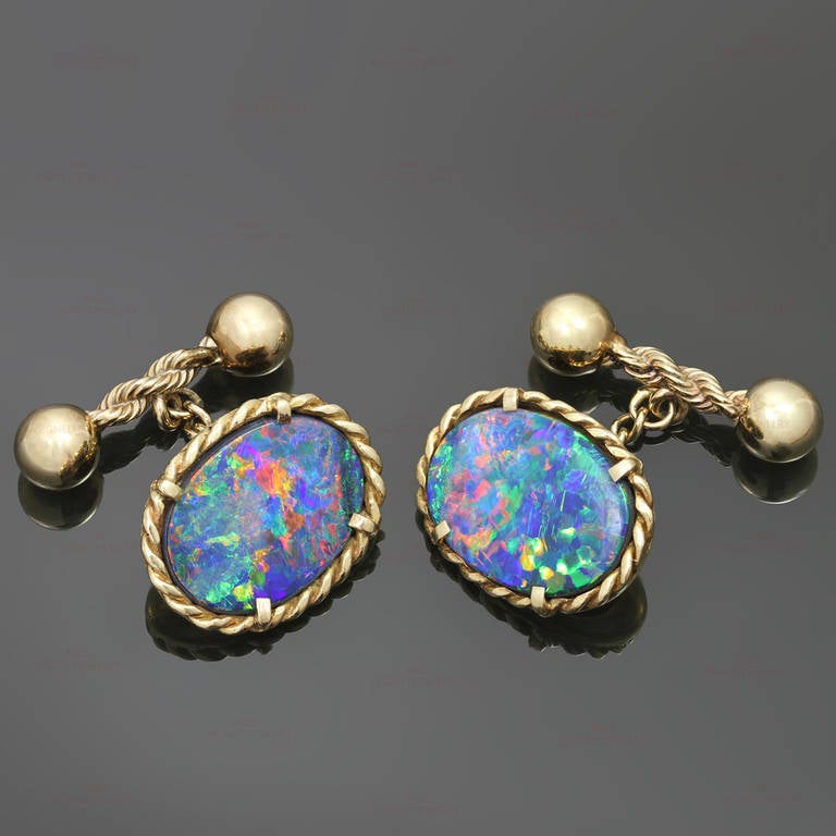 These magnificent custom-made cufflinks feature outstandingly glowing oval doublet black opals set in14k yellow gold twisted rope frames.  Measurements: 0.62