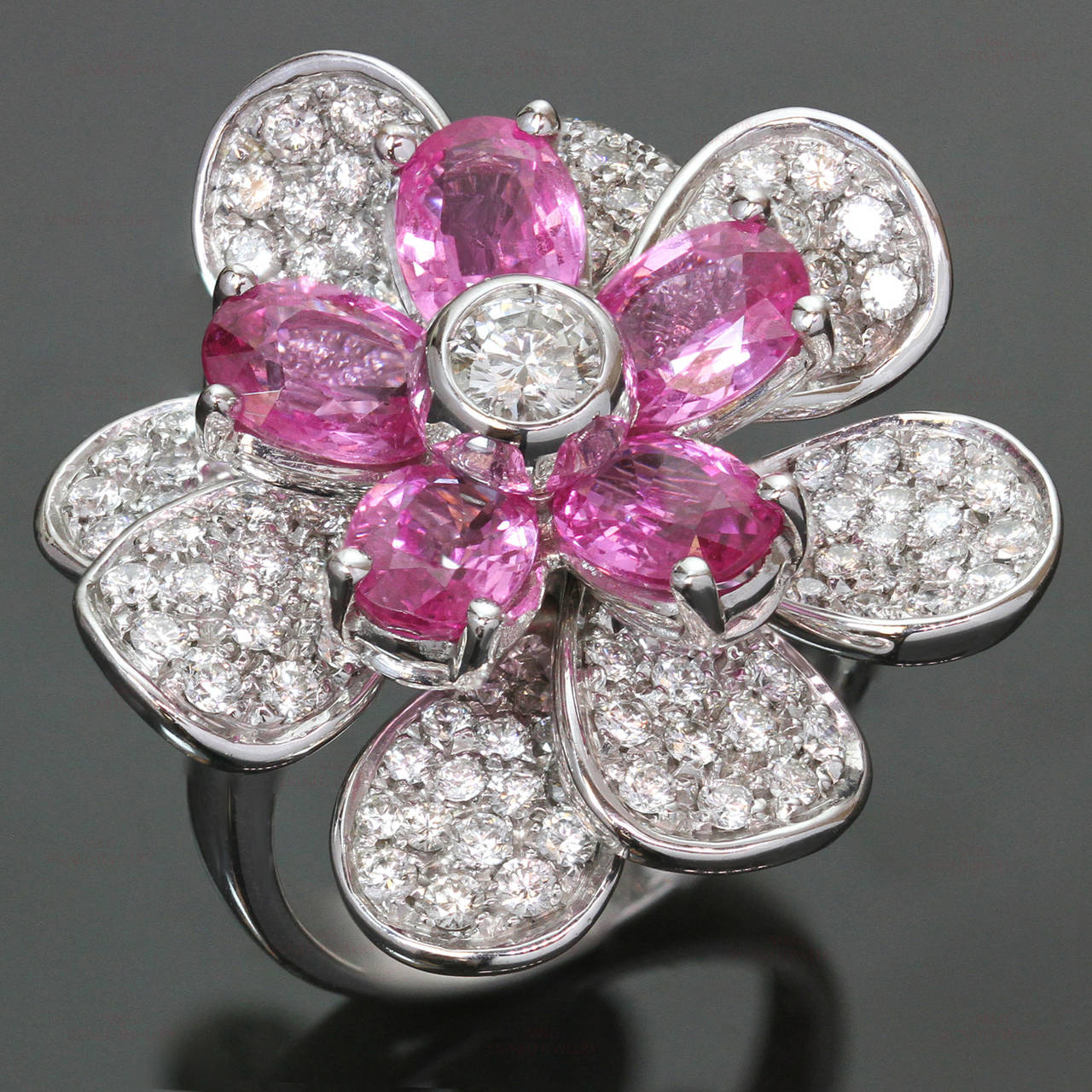 This stunning Luca Carati ring features a vibrant flower design crafted in 18k yellow gold and set with faceted pink sapphires and and sparkling round brilliant-cut diamonds of an estimated 3.0 carats. Made in Italy circa 2000s. Measurements: 1.10
