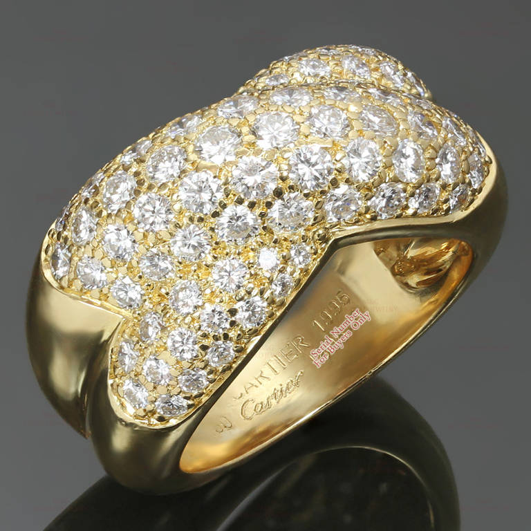 This stunning Cartier dome band ring features a two-row crossed design made in 18k yellow gold and pave-set with sparkling brilliant-cut round E-F VVS1-VVS2 diamonds of an estimated 2.30 carats. Circa 1995. Measurements: 0.43