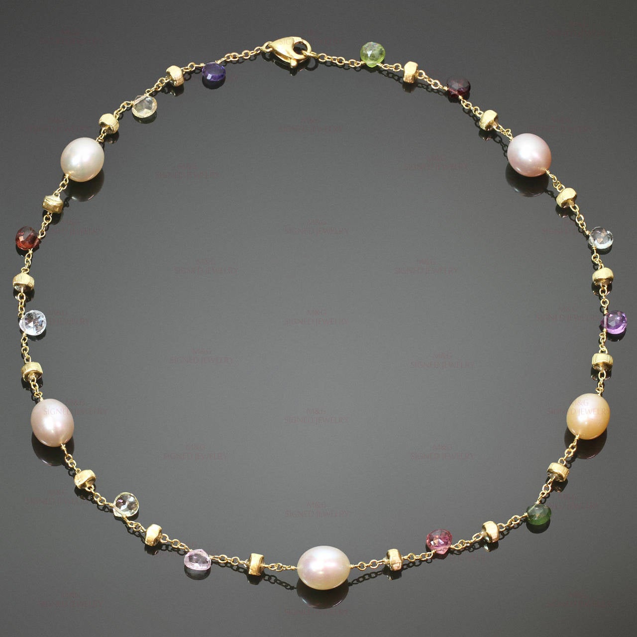 This stunning Marco Bicego necklace from the playful Paradise collection features a vivid design of tabeez-cut semi-precious stones, hand-engraved 18k yellow gold beads, and freshwater cultured pearls. Made in Italy circa 2010s. Measurements: 16