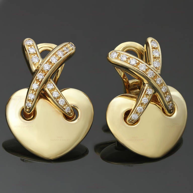 These romantic heart-shaped clip-on earrings from Chaumet are made in 18k yellow gold and feature an X design set with round brilliant-cut F-G VVS2-VS1 diamonds of an estimated 0.60 carats. Classic and timeless. Measurements: 0.70