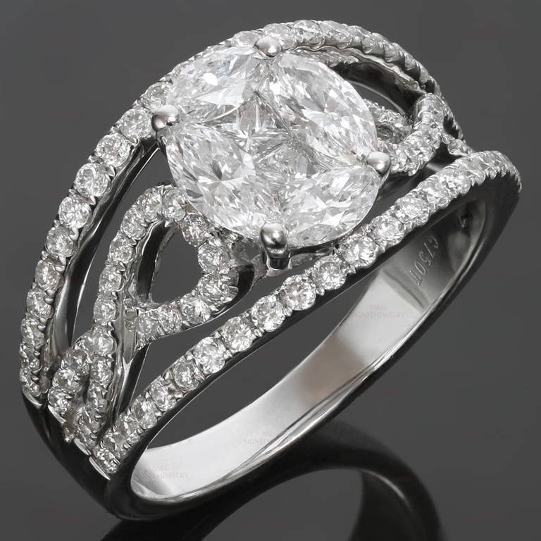 This gorgeous ring is made in 18k white gold and set with F-G VVS2-VS1 diamonds of an estimated 2.10 carats - 4 marquise-cut diamonds of an estimated 0.86 carats, 2 square-cut diamonds of an estimated 0.28 carats, and 88 round diamonds of an