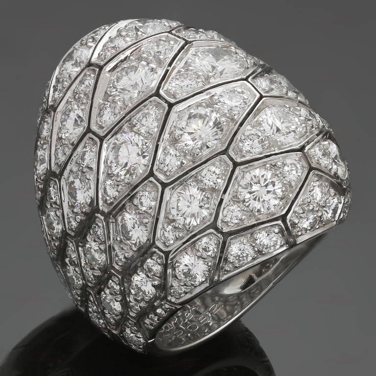 This modern dome ring from Cartier's Serpentine collection is made in 18k white gold and beautifully pave-set with round brilliant-cut E-F VVS2-VS1 diamonds of an estimated 7.75 carats. Chic and fabulous. Measurements: 1.18" (30mm) width. The