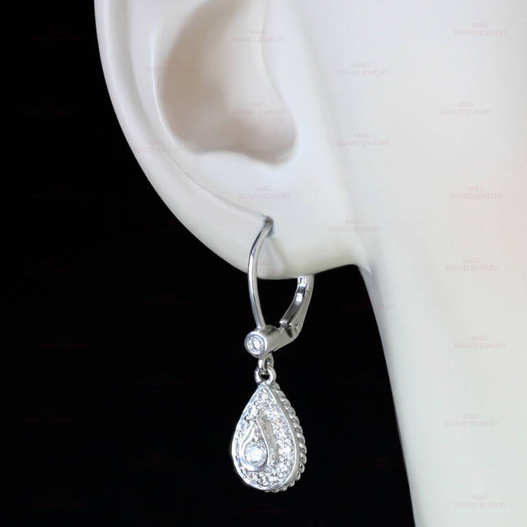 These modern Italian earrings are made in 18k white gold and feature pear-shaped drops set with round brilliant-cut F-G VS1-VS2 diamonds of an estimated 0.60 carats. A timeless design. Measurements: 0.31" (8mm) width, 0.98" (25mm) length.