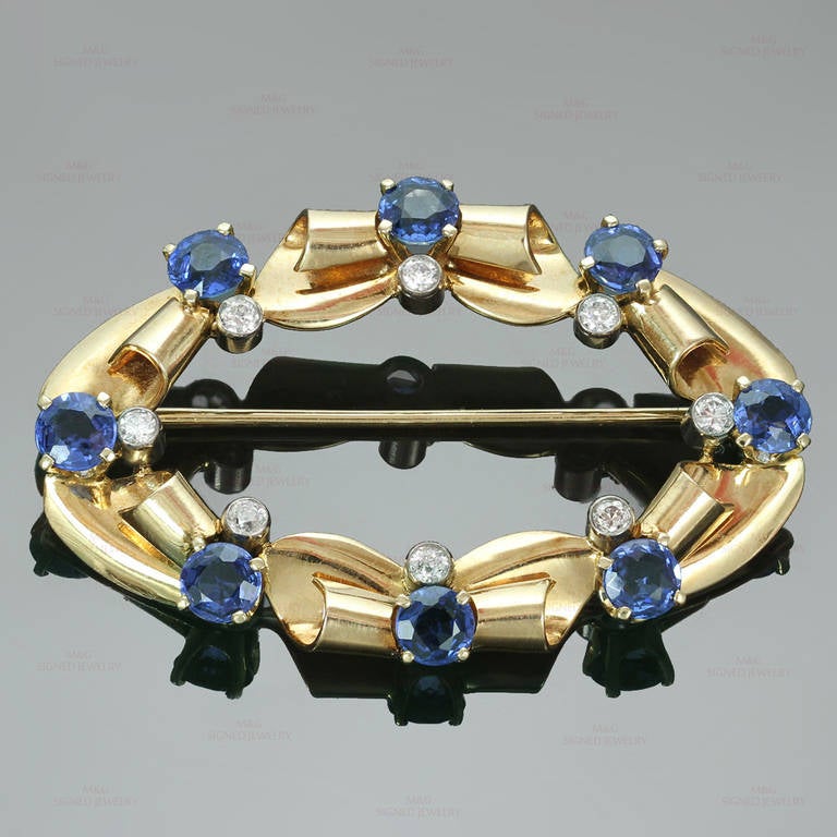 This rare Tiffany & Co. oval brooch from the retro period is made in 14k yellow gold and set with natural bright round blue sapphires of an estimated 3.20 carats and beautiful old-cut F-G VVS2-VS1 diamonds of an estimated 0.45 carats. Elegant and