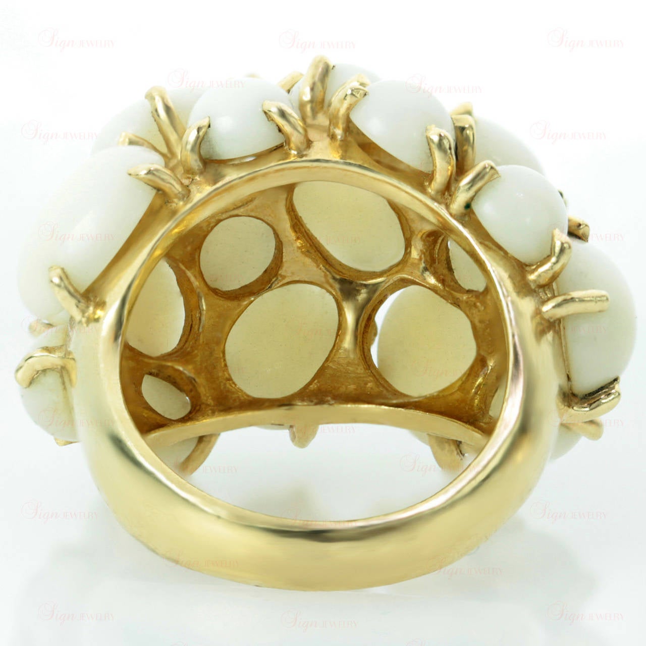 This circa 1960s cluster dome ring is made in 14k yellow gold and prong-set with natural multi-shaped round and oval white corals. An enchanting design from Celino.  Measurements: 0.74