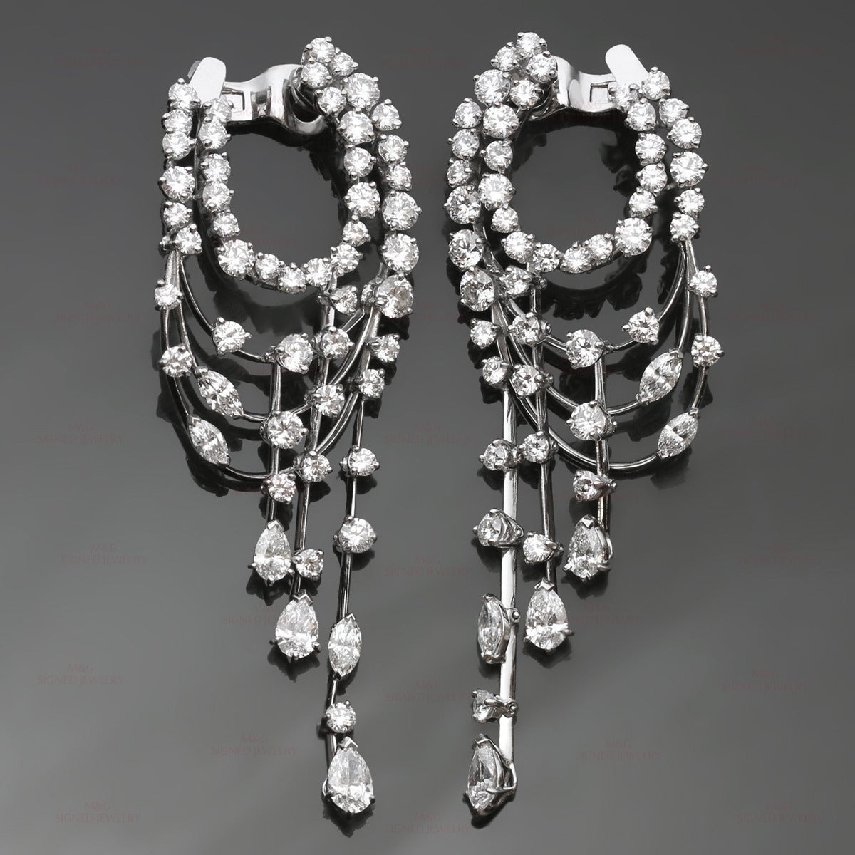 These magnicient chandelier earrings by Van Cleef & Arpels are made in 18k white gold and set with an estimated 9.50 to 10 carats of multi-shaped E-F VVS2-VS1 diamonds. Earrings are completed with clip-on fittings, posts for pierced ears can be