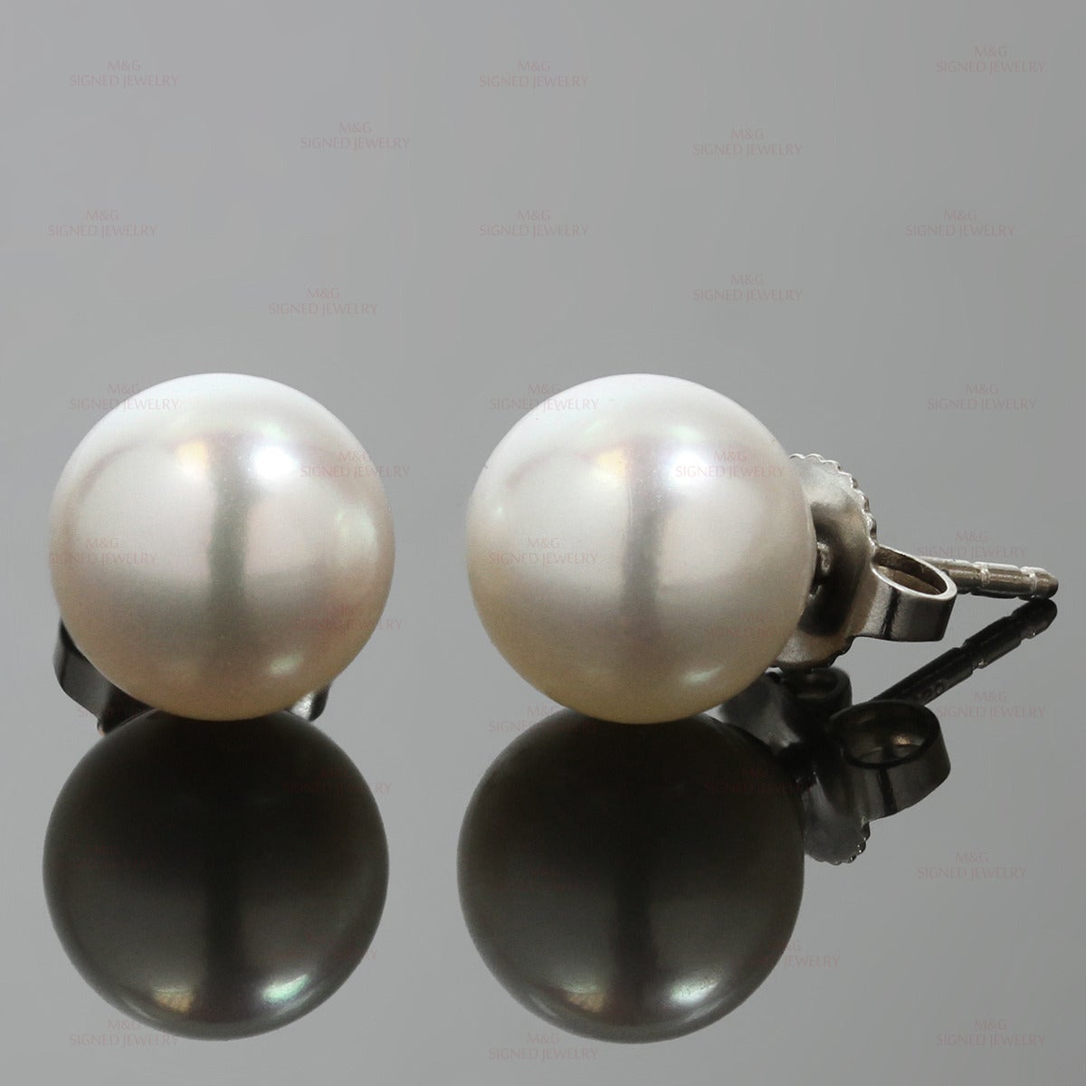 Lovely modern stud earrings from the Signature collection by Tiffany & Co. Made in 18k white gold and set with 8.5mm - 9.0mm cultured Akoya pearls. Circa 2014. Measurements: 0.35