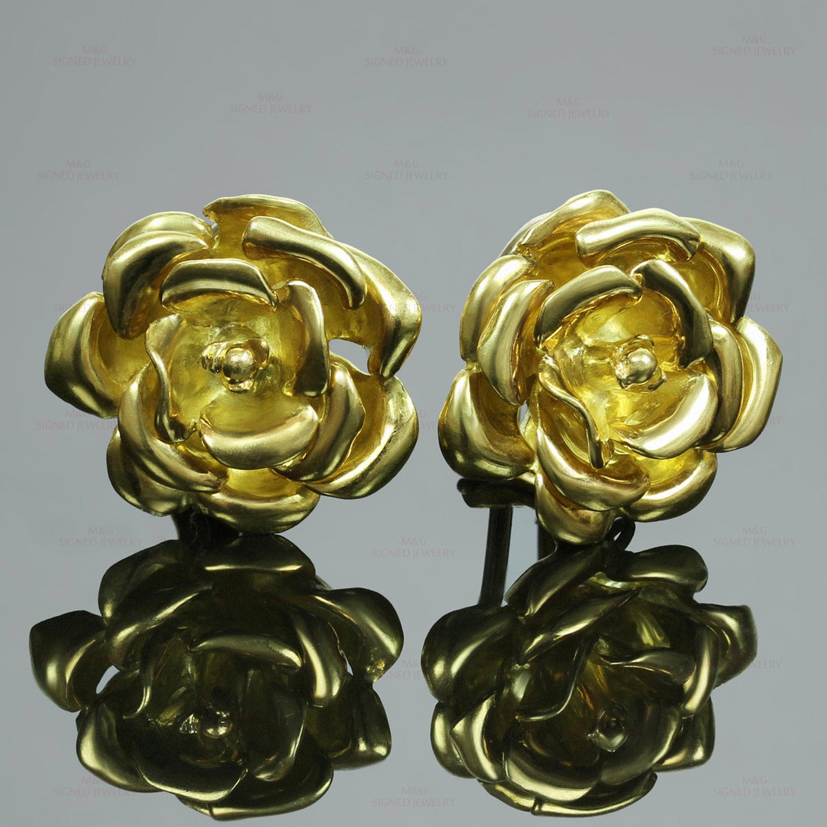 These Tiffany & Co. earrings feature a graceful rose-shaped design made in solid 18k yellow gold. Italy circa 1980s. Measurements: 0.78