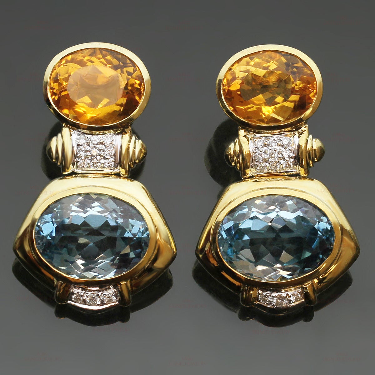 These chic and elegant earrings are made in 18k yellow gold and set with faceted oval blue topaz stones measuring approximately 12.0mm x 16.0mm and faceted oval orange citrine stones measuring approximately 10.0mm x 13.0mm, accented with pave