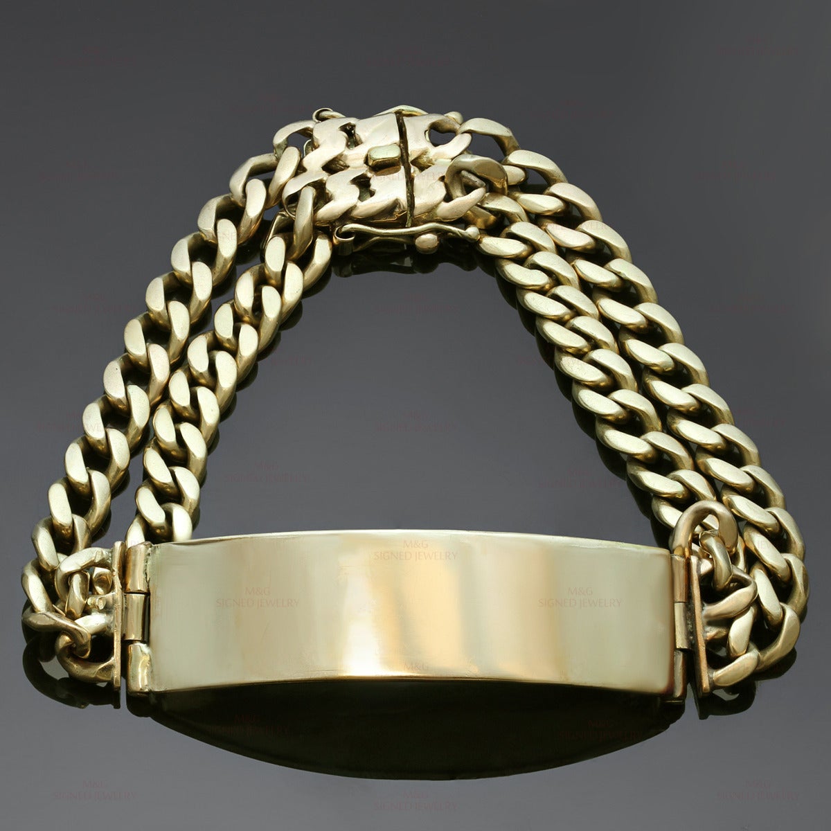 This classic men's bracelet features an engravable id plate and a double curb-link chain design crafted in 18k yellow gold. Made in United States circa 1980s. Measurements: 0.59