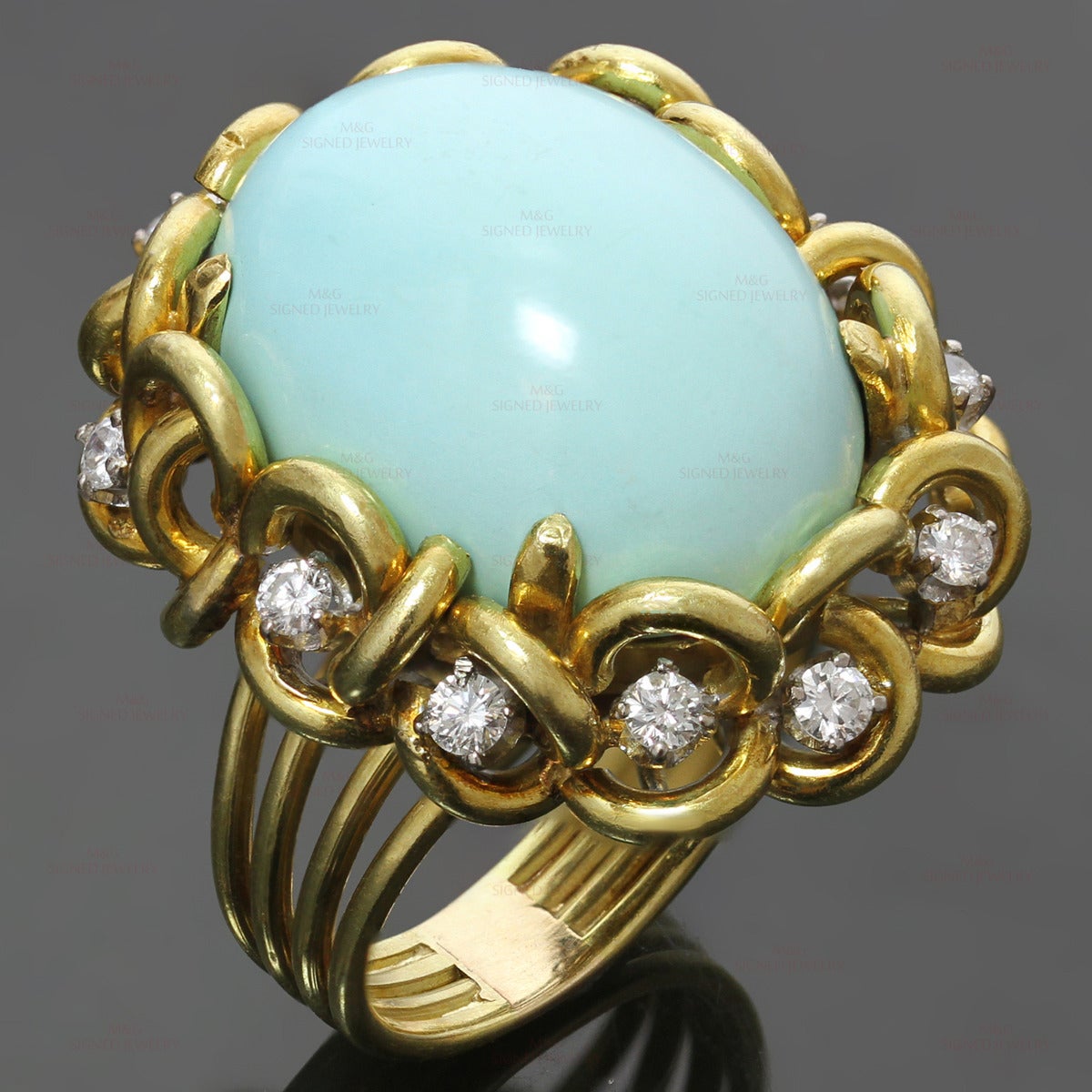 This gorgeous ring features a oval 17.0mm x 23.0mm turquoise stone set in 18k yellow gold and surrouned with prong-set round brilliant-cut G-H VS2-SI1 diamonds of an estimated 1 carat. Signed JHL for makers mark. United States circa 1960s.