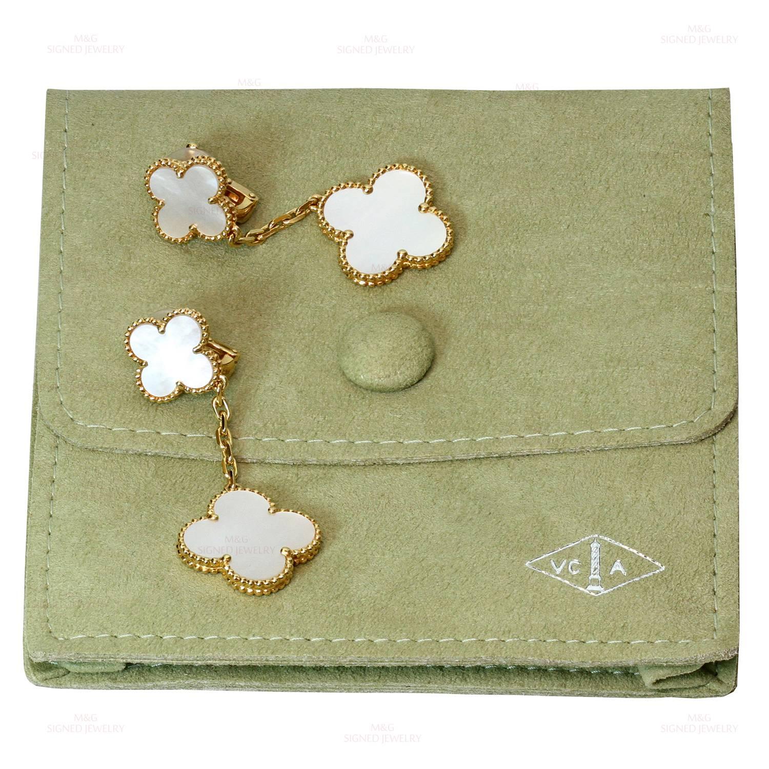 These elegant Van Cleef & Arpels drop earrings from the Magic Alhambra collection are crafted in 18k yellow gold and feature a pair of lucky clover motifs beautifully inlaid with mother-of-pearl in round bead settings. Measurements: 0.78