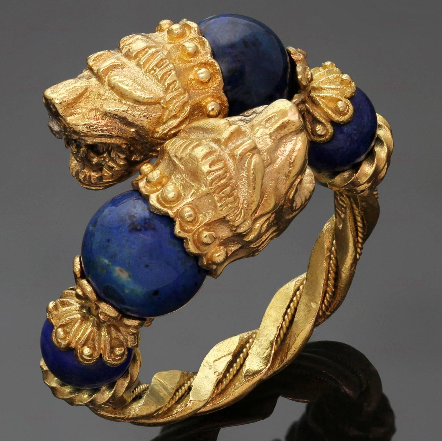 This fabulous Ilias Lalaounis ring features a fiery two-headed chimera motif intricate crafted in 18k yellow gold and accented with blue soladite beads. Made in Greece circa 1970s. Measurements: 0.70