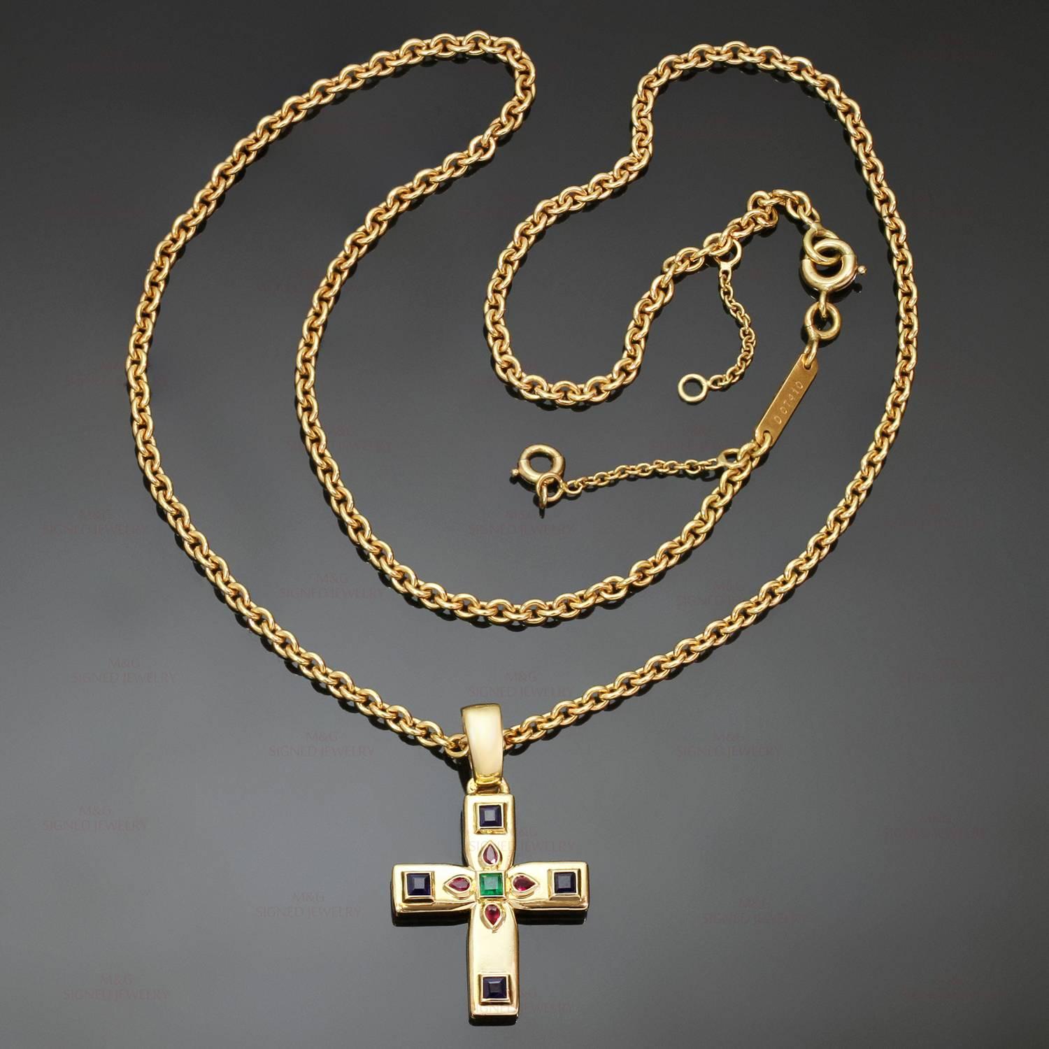 This fabulous Cartier cross is made in 18k yellow gold and set with faceted rubies, sapphires, and emerald. The cross measurements are 18mm x 21mm (29mm with hook). Complete with the original Cartier chain. The Byzantine motif was designed by Louis