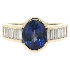 14k Yellow Gold 3.3ctw Oval Half Bezel Tanzanite w/ Baguette Diamond Sides Ring