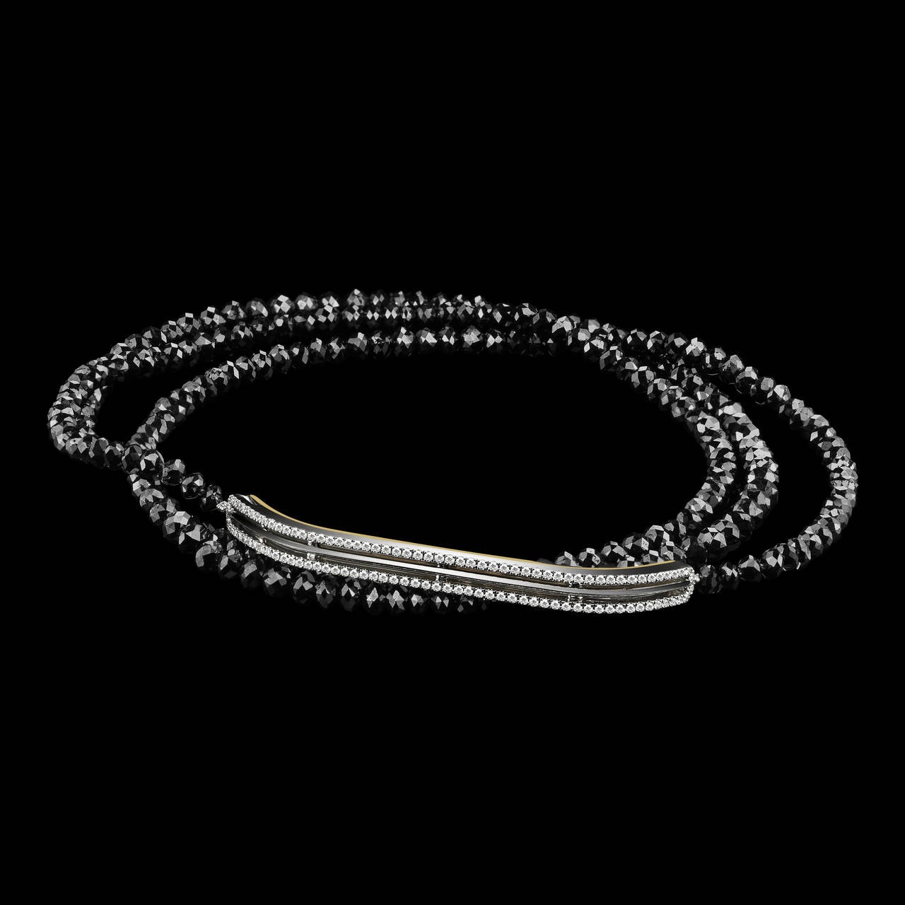 Narrow knife-edged Diamond bar bracelet with Black Diamond strand. Total diamond weight is 35.52 carats. Bracelet features 106 round-cut G VS 1mm white Diamonds with a total weight of 0.52 carats, and 171 Black Diamonds measuring 3.7 x 4.7 mm each