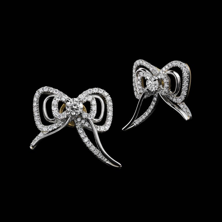 *Please contact us for more information on this piece or on creating your own Alexandra Mor custom Design. 

A pair of Alexandra Mor Diamond bow stud earrings set with 2 Brilliant-Cut Diamonds with a total weight of 0.26 carats, and 122 Round melee