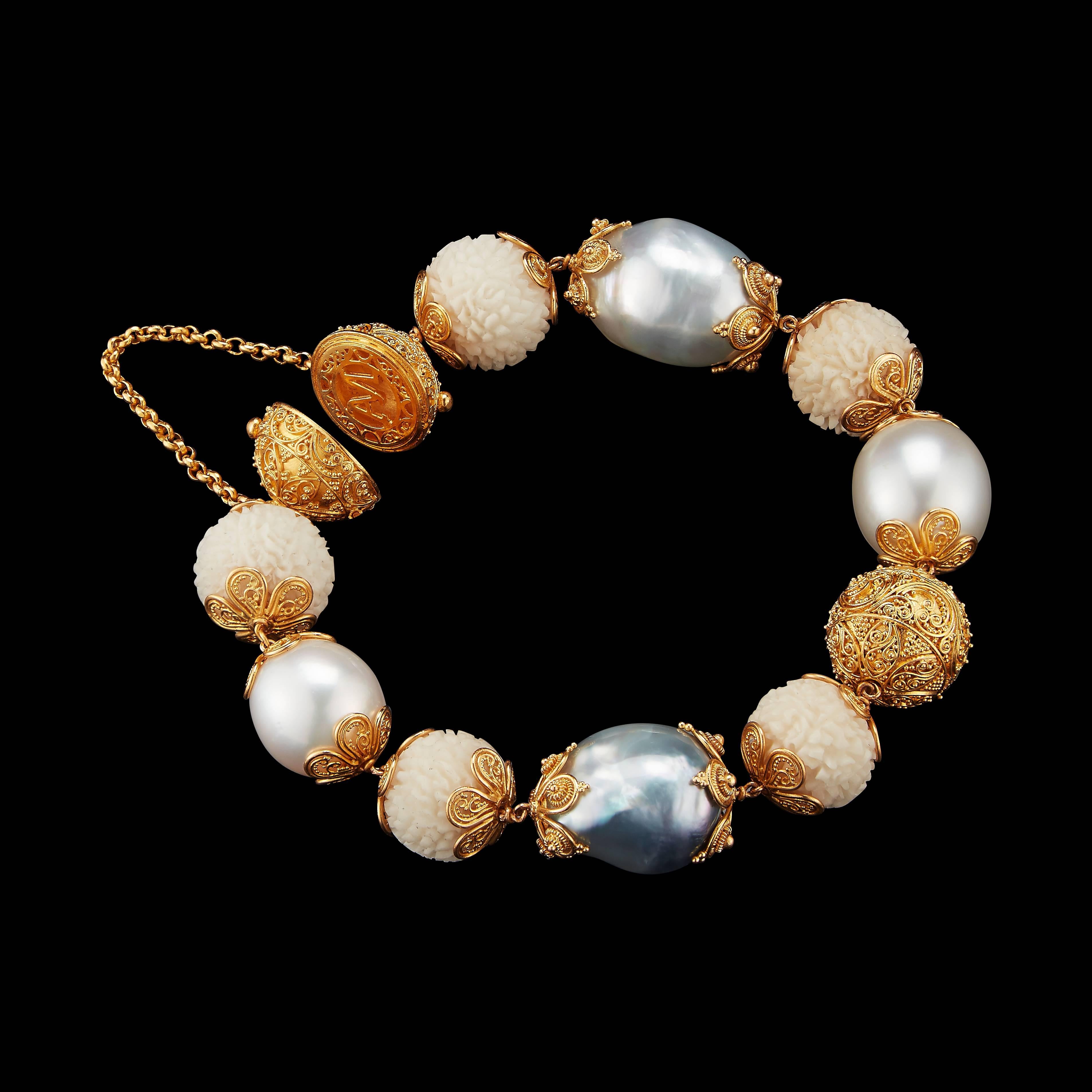 This bracelet features wild-harvested carved Tagua Rudraksha Beads, Baroque pearls and yellow gold filigree spheres set in 22 karat yellow gold with Alexandra Mor logo clasp. Prolific, internal carvings in 22 karat yellow gold are inspired by the