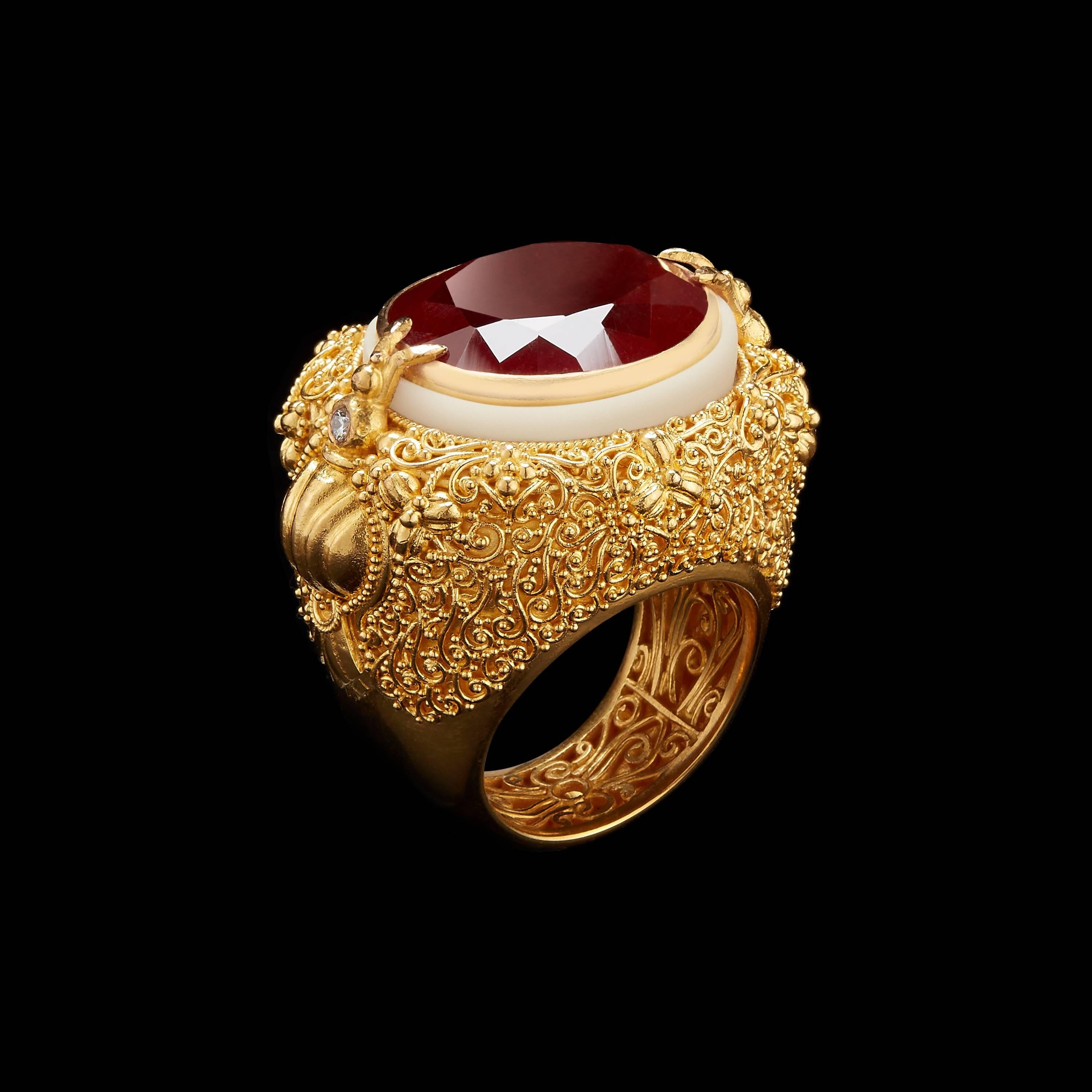 *Please contact us for more information on this piece or on creating your own Alexandra Mor custom Design. 

This ring features an Oval-cut rich orange Spessartite Garnet weighing 24.40 Cts set in a 22 karat gold bezel accented with a carved,