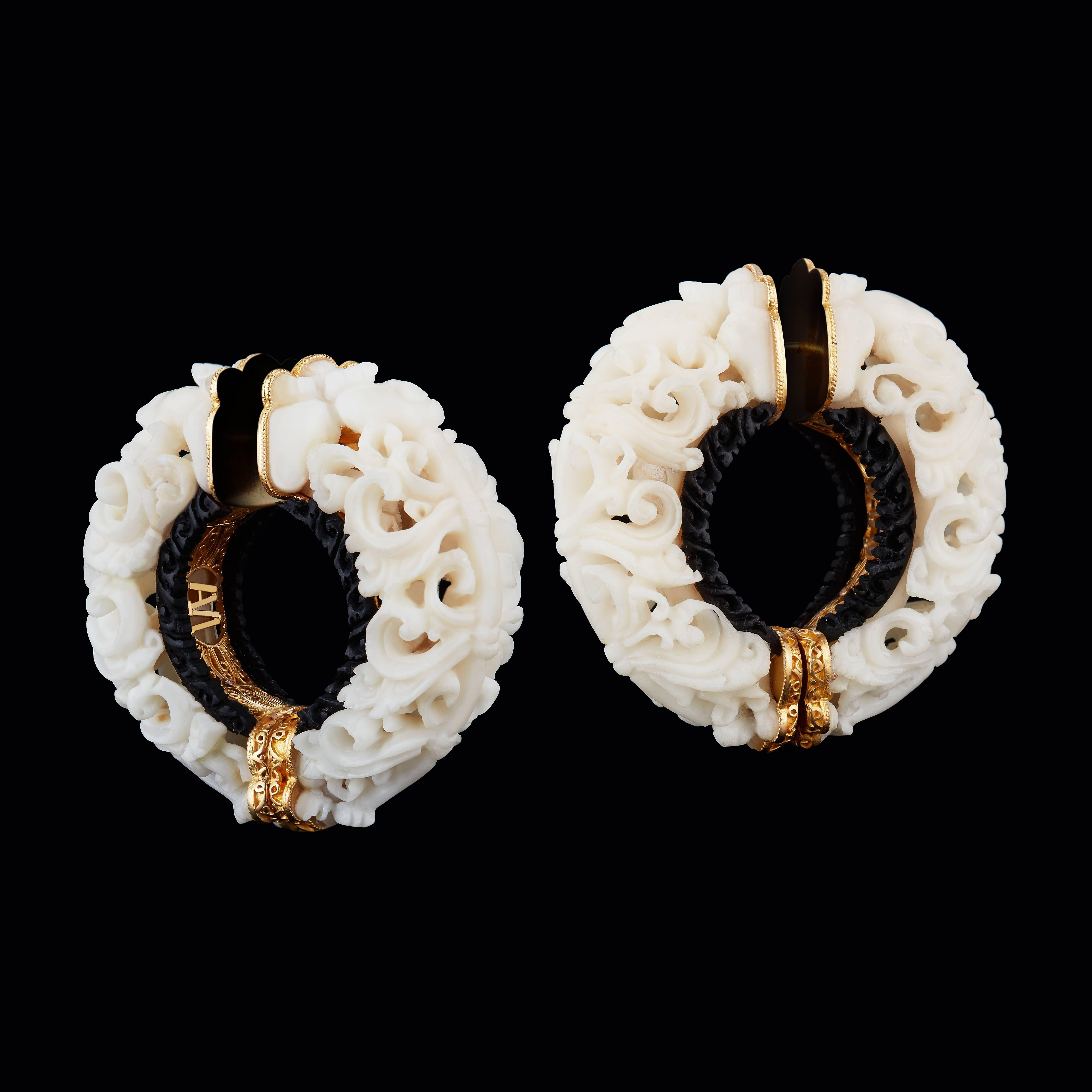 A pair of carved, wild-harvested Tagua seed Subang hoop earrings showcase the pure white and hard surface of the Tagua seed that is nearly identical to ivory. Offset and complimented with a dark Areng Ebony wood rim, the design for these earrings is