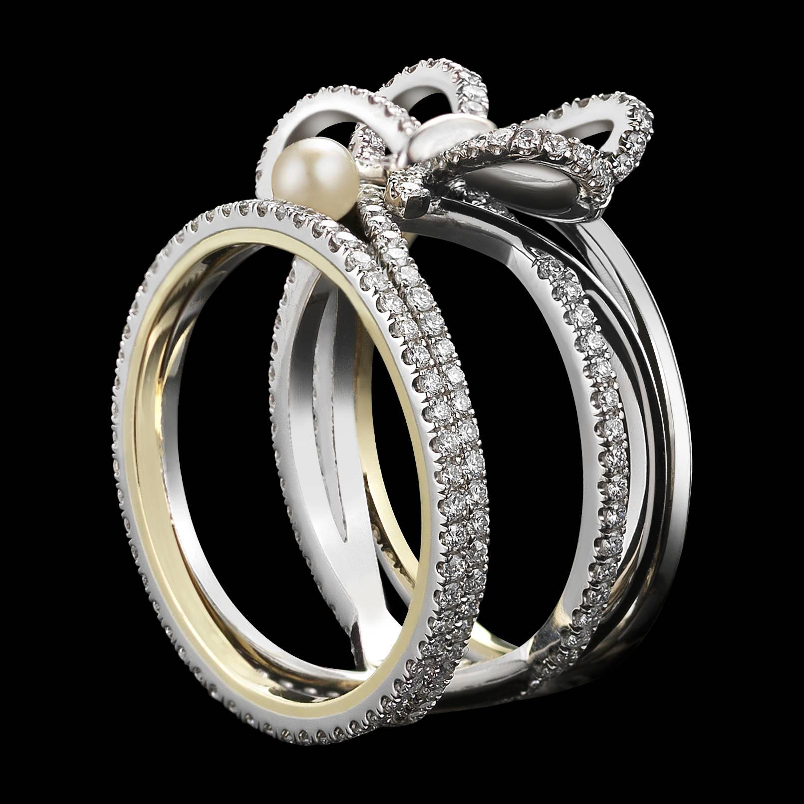 An Alexandra Mor contemporary Diamond Bow and Pearl ring set with Alexandra Mor signature details of 1mm knife-edged wire and 1mm floating Diamond melee weighing a total of 1.13 Cts. 

Ring size 7.75. (Can be Sized)

This Item is New, and an