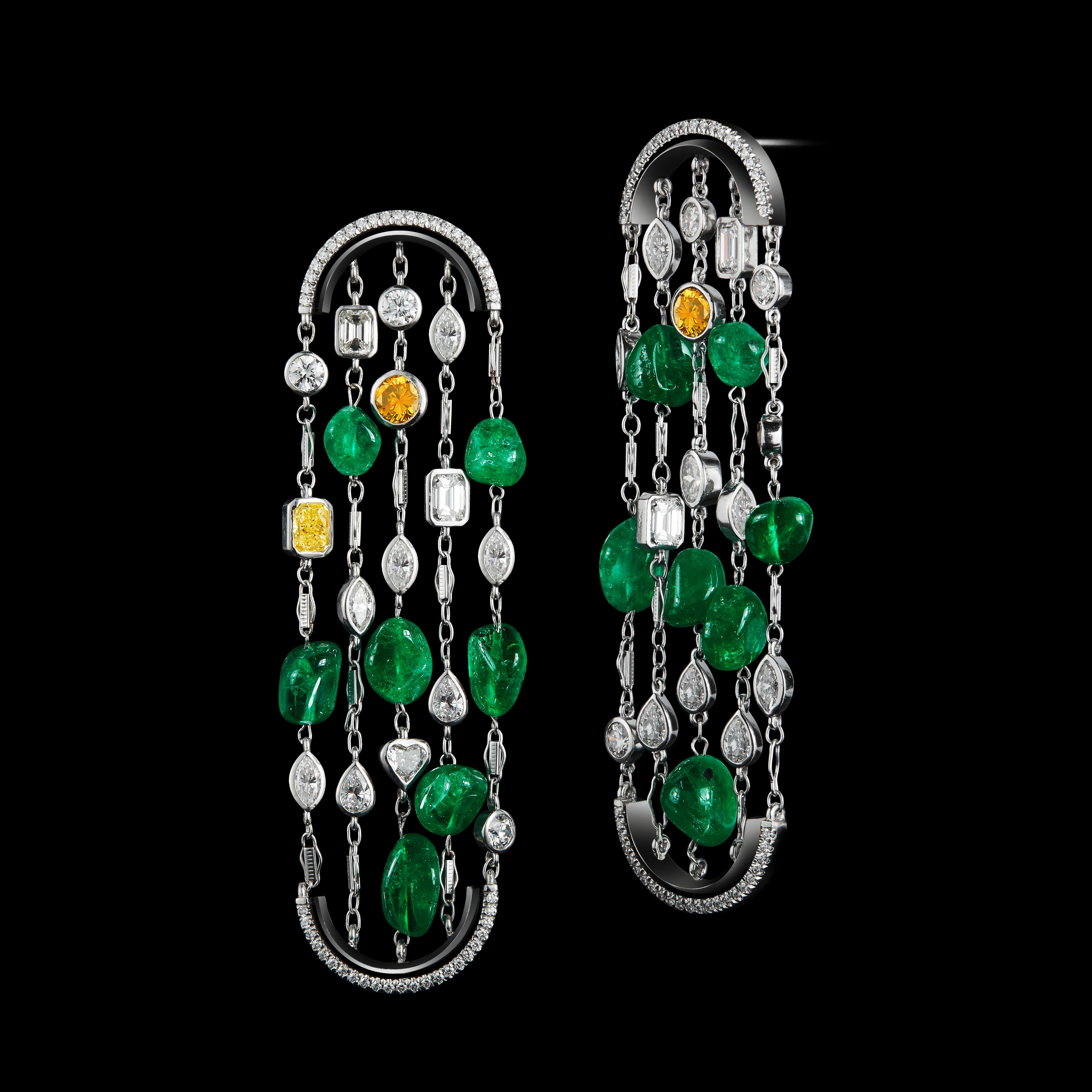 An Alexandra Mor One-Of-a-Kind arched earrings featuring Ethically-mined *Muzo Mine Colombian Emerald Nuggets and a mixture of Fancy, Brilliant, Emerald, Oval, Marquise, Heart-shape, and Radiant-Cut Diamonds. Earrings are set in platinum and 18