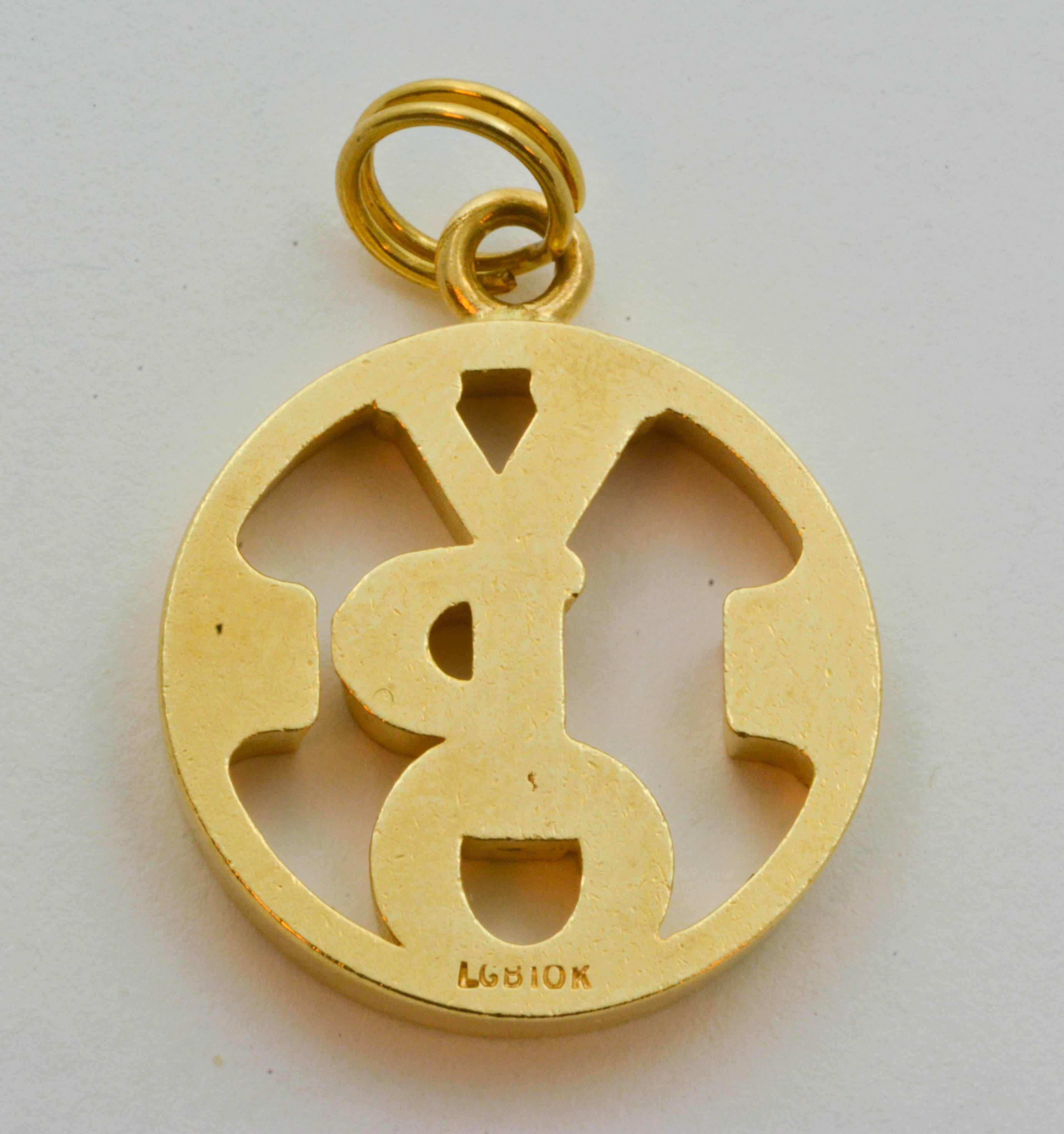 This unique, 14kt yellow gold charm is dated 1974 and centers around a cutout of the letters “YPO.” Measuring 19.5mm in diameter and weighing 6.1g, this charm is a piece with a unique and meaningful history.