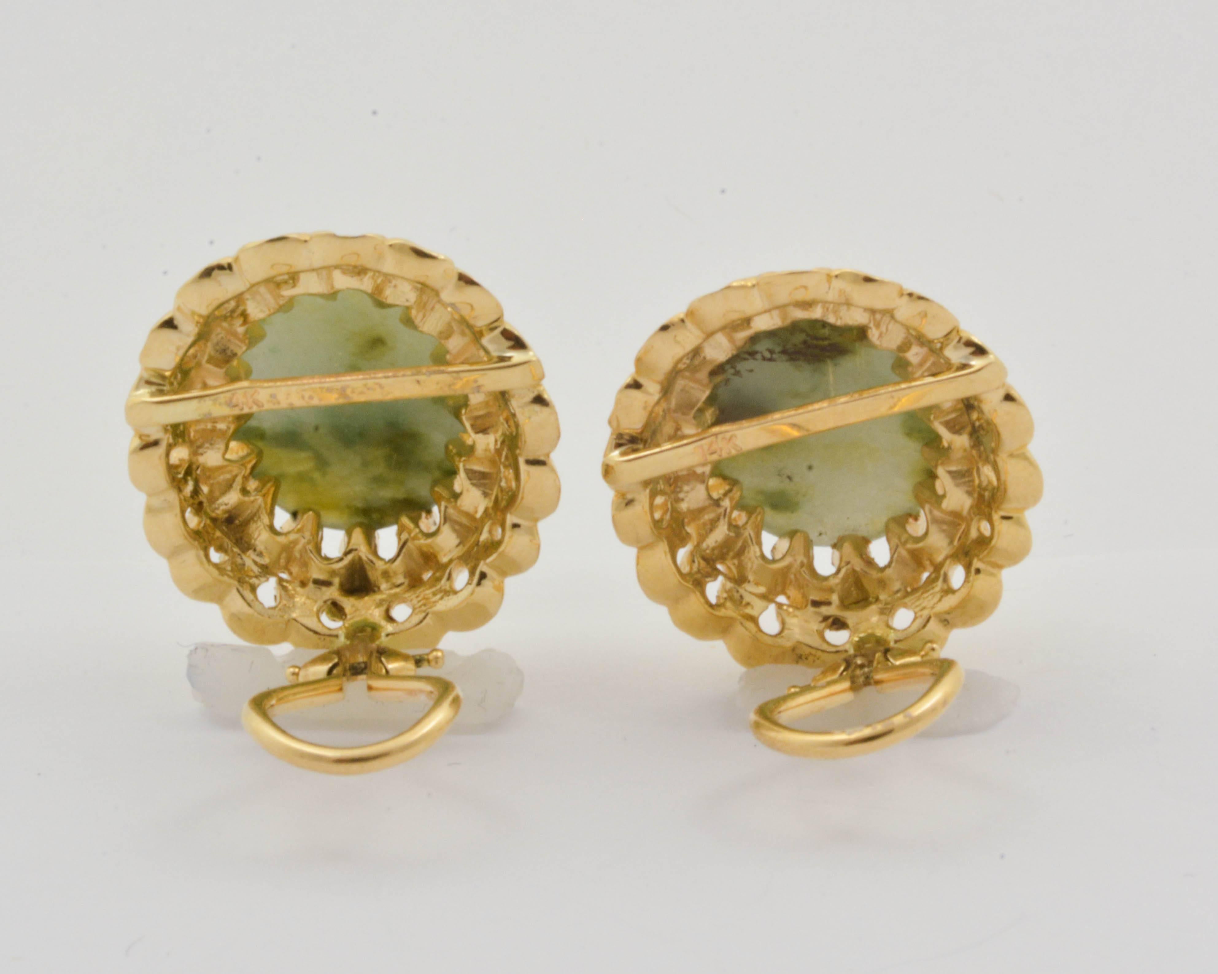 An exotic pair of variegated, cabochon-cut jade stones is displayed in lovely 14kt yellow gold in these clip-on earrings. The gold is fashioned to resemble ruffles. Each jade is set with scalloped prongs, adding detail and beauty to the unique