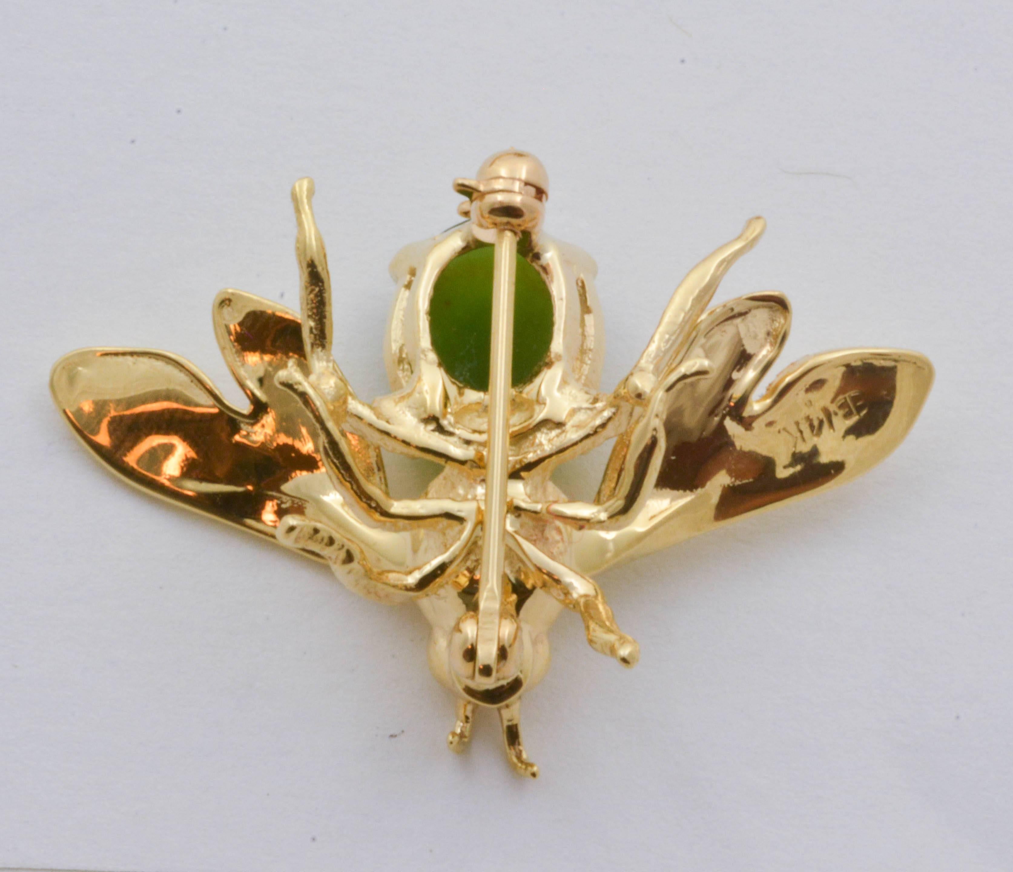 Crafted from 14kt yellow gold, this brooch creates a mesmerizingly life-like design with a 2.75 carat jade cabochon stone. The jade makes up part of an expertly crafted bee, and is securely set with a simple yet elegant four-prong mounting.