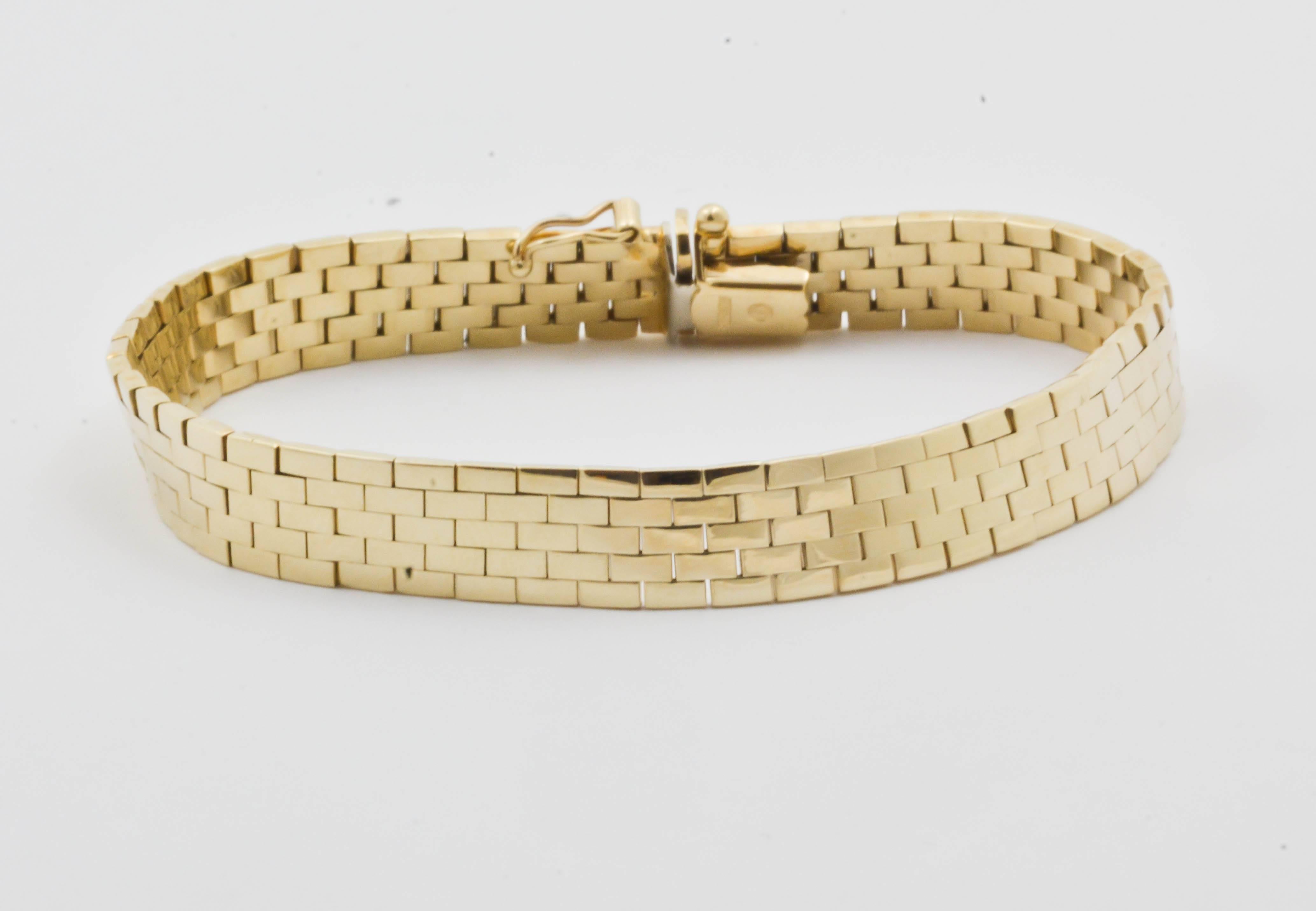 A classic 14kt yellow gold brick patterned bracelet is stunning with it's beautiful high polished mirror finish.  The bracelet measures 8.25 mm wide and 1.5 mm thick.  The bracelet feels so soft and supple with its well executed hinges.  The