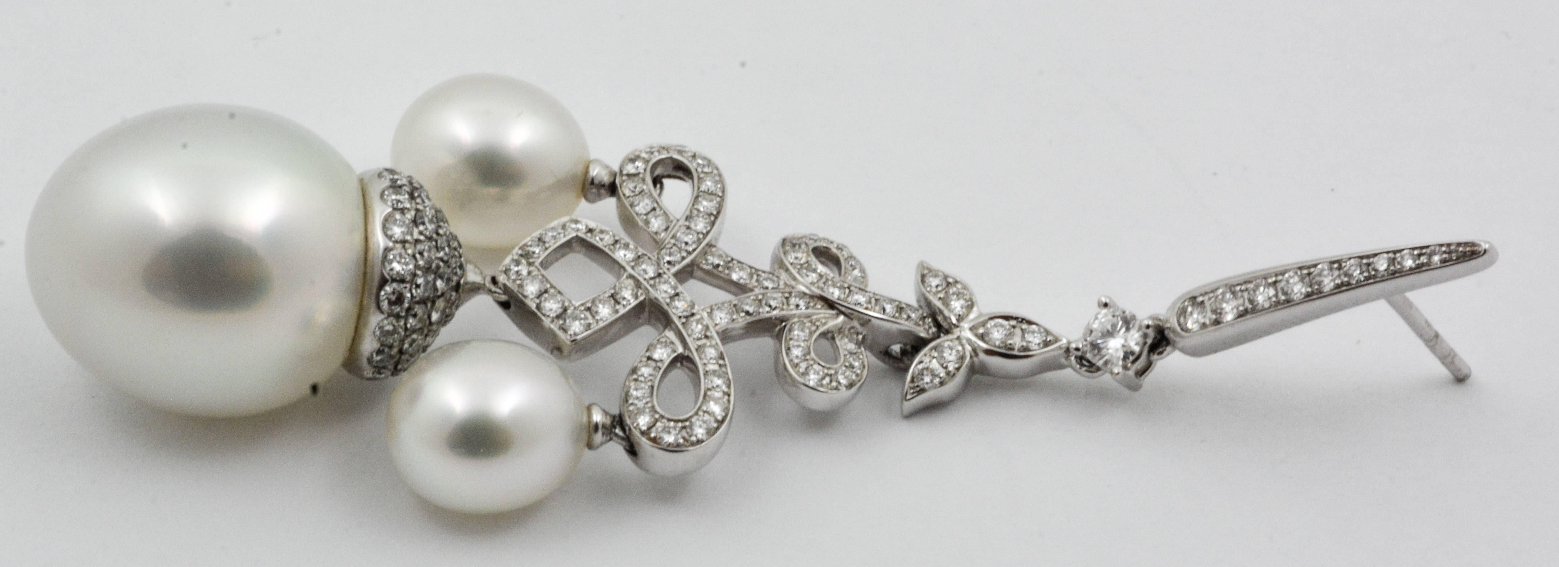 Diamonds and pearls hanging on chandelier style earrings are irresistible to any lady! These classic chandelier style South Seas pearl earrings are crafted with 18kt white gold and feature three lovely, white South Sea pearls each. The center pearls