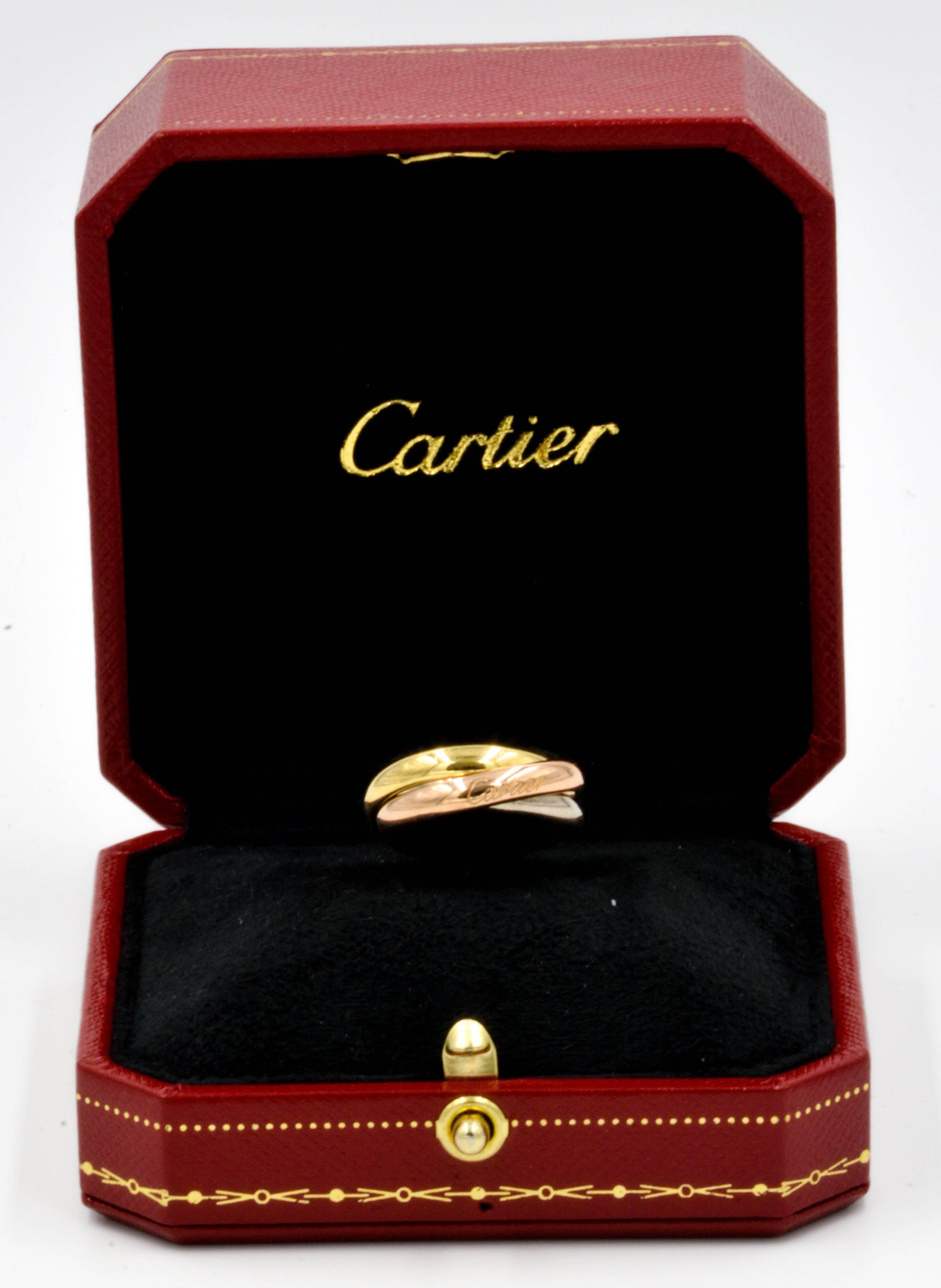 18kt yellow gold, rose gold, and platinum combine flawlessly in this classic Cartier trinity ring. With the Cartier name engraved on the outside and a unique design, this ring is sure to catch every eye. The ring is made to fit finger size 5, and
