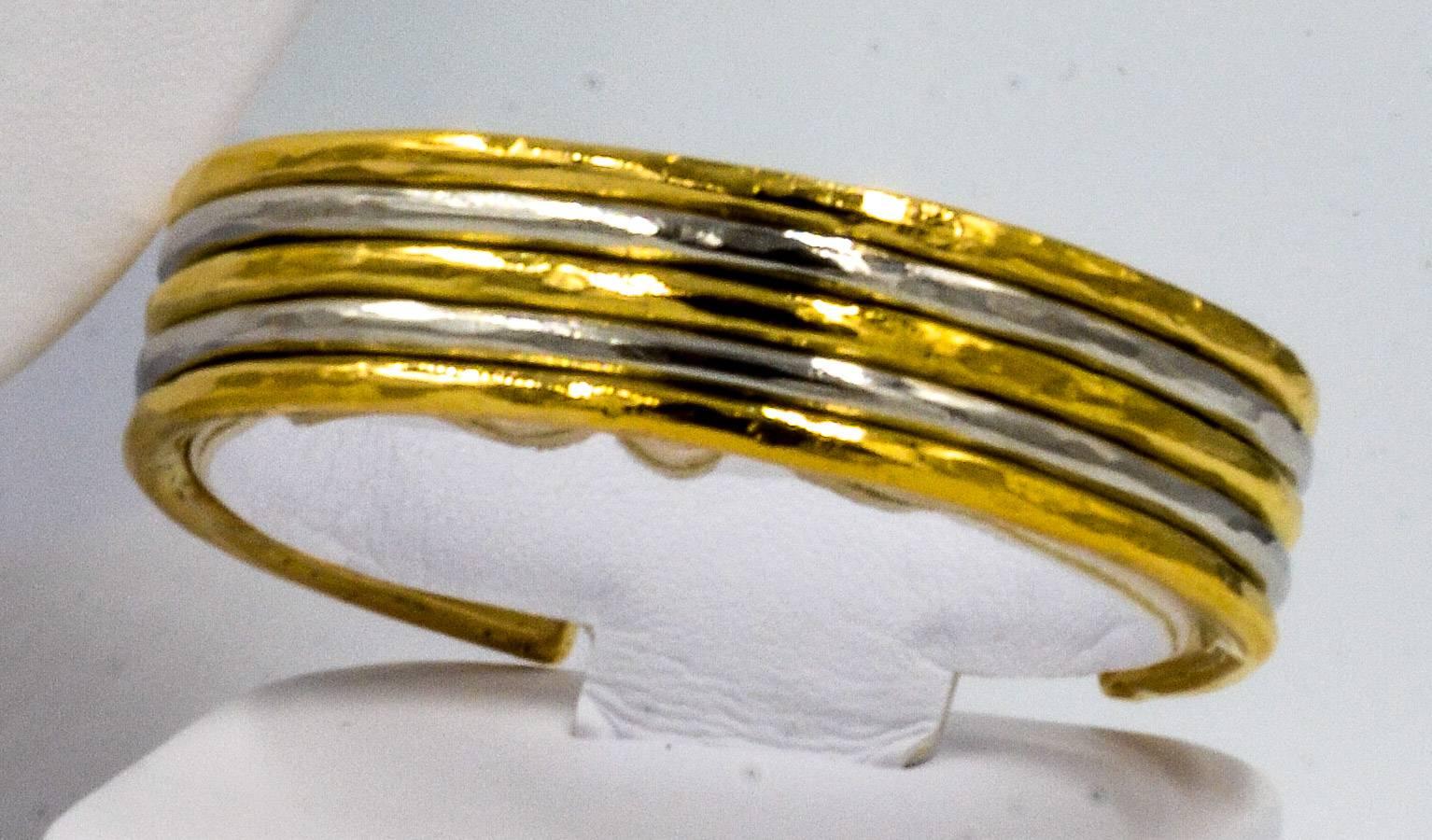 A unique and classic high contrasting two tone 18kt yellow gold and platinum Jean Mahie cuff bracelet.  This is a very unique Jean Mahie cuff due to the artful use of the two tone metals finished in the classic Jean Mahie hammered finished style.