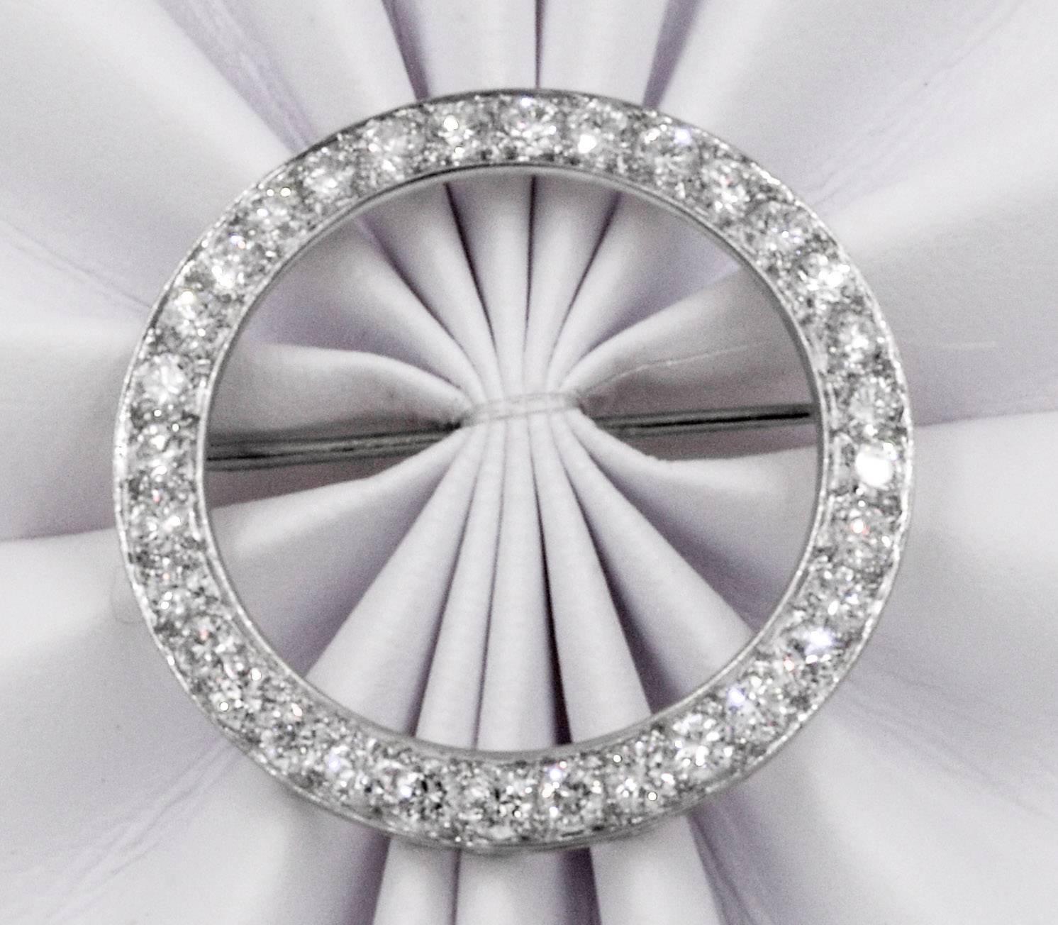This timeless platinum brooch is set with thirty round brilliant cut diamonds that have an approximate total weight of 2.50 carats which have G color and VS clarity.  The pin is designed in an elegant circle each diamond expertly let using four